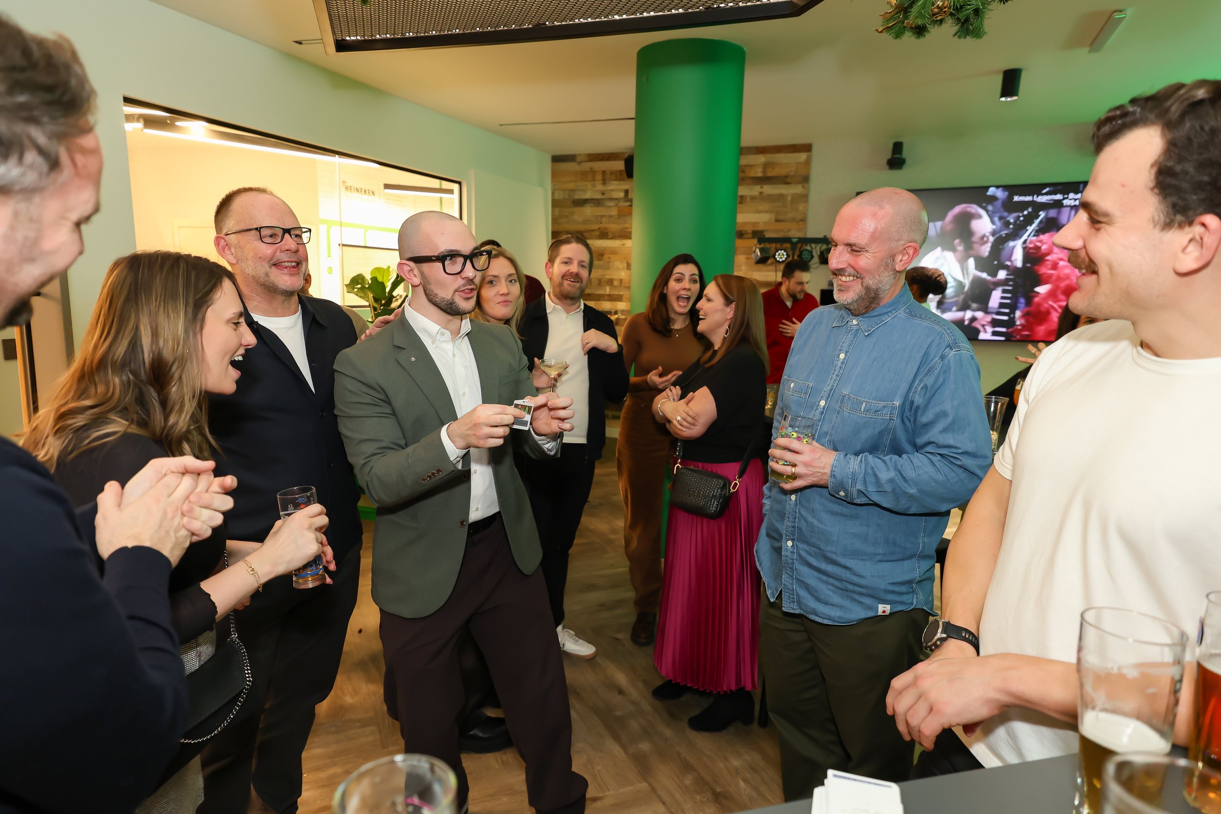 Corporate attendees participating in a fun magic moment with the magician during the holiday event.