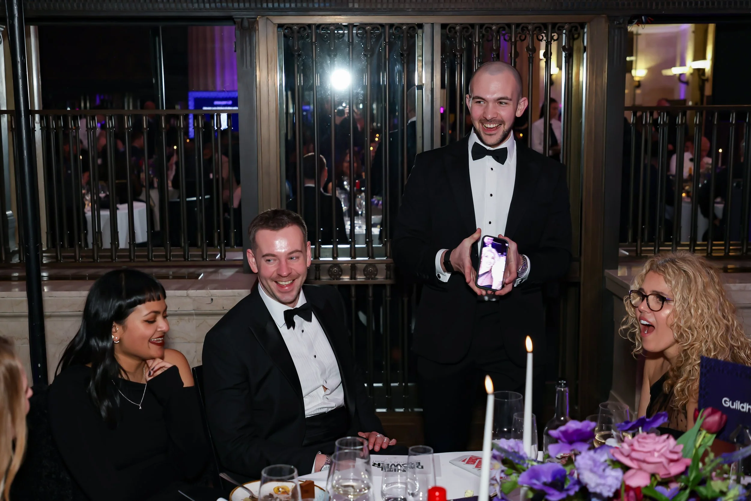 A professional magician delivering table magic during a formal corporate dinner.