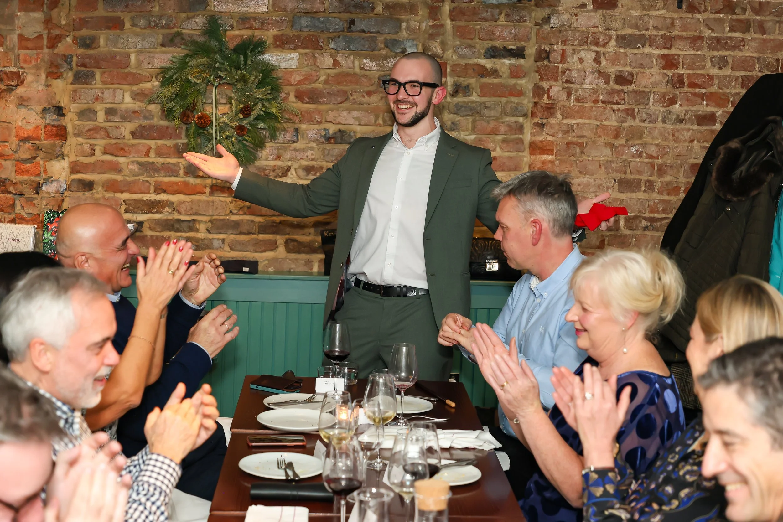 Magician wrapping up an engaging corporate party surrounded by happy guests.