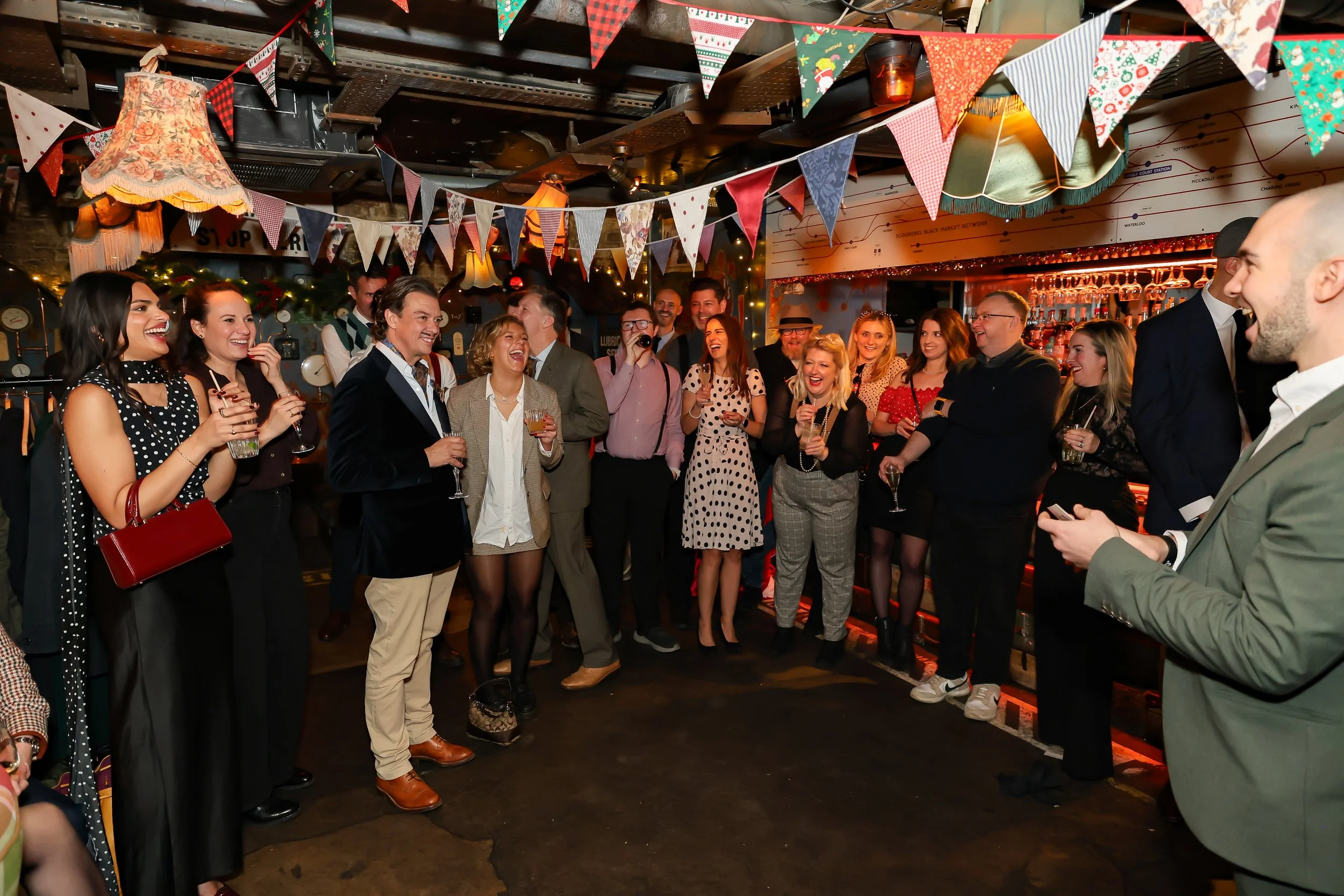 Audience gathered to watch a live magic show at a corporate event in London.
