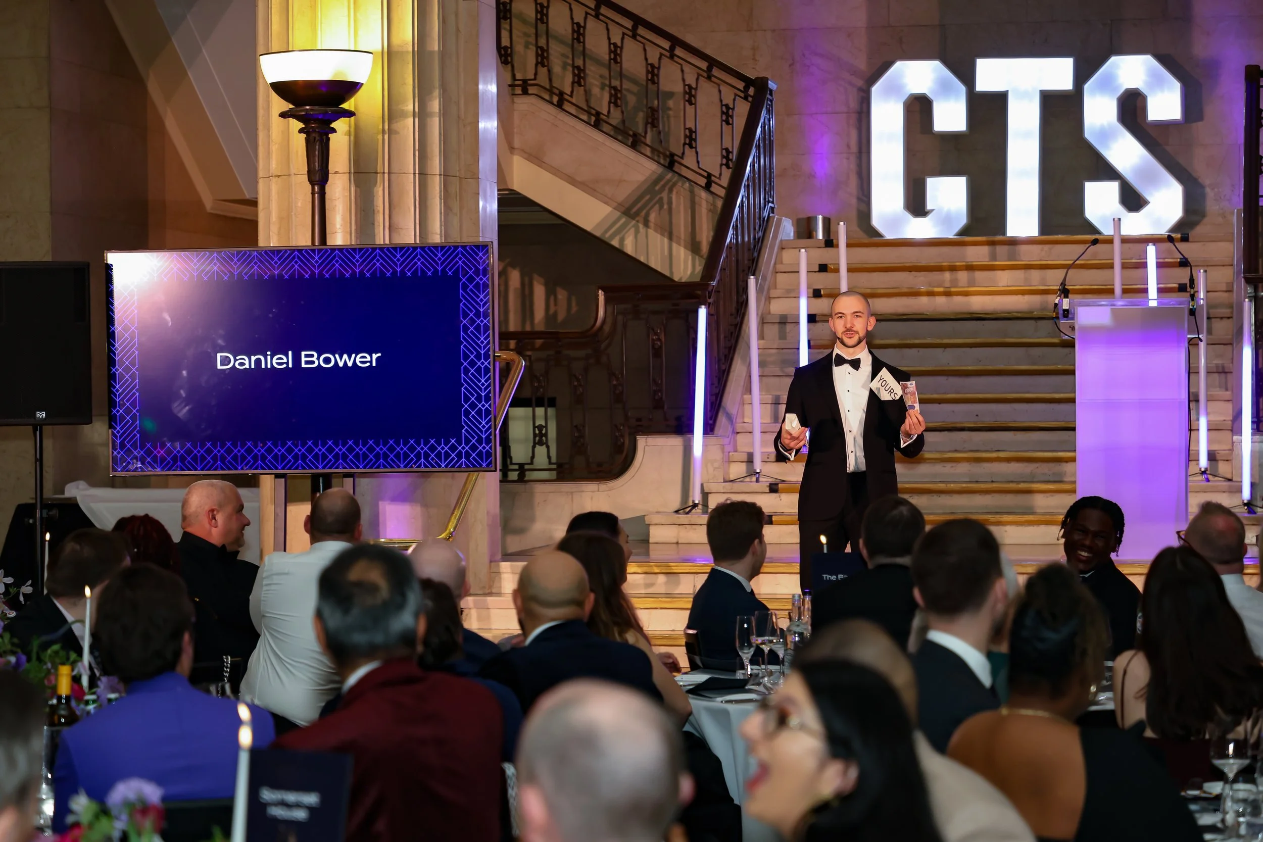 A skilled event host & magician balancing structure and spontaneity to keep the room energised and focused.