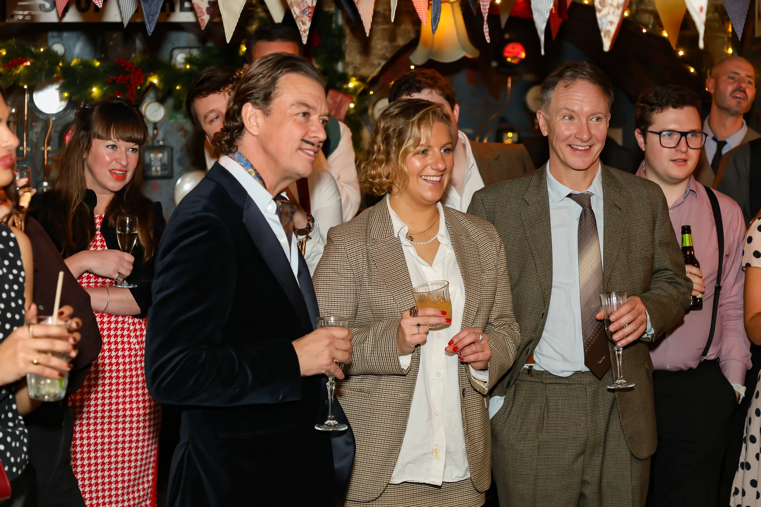 Corporate guests enjoying a close-up magic performance by a London magician.