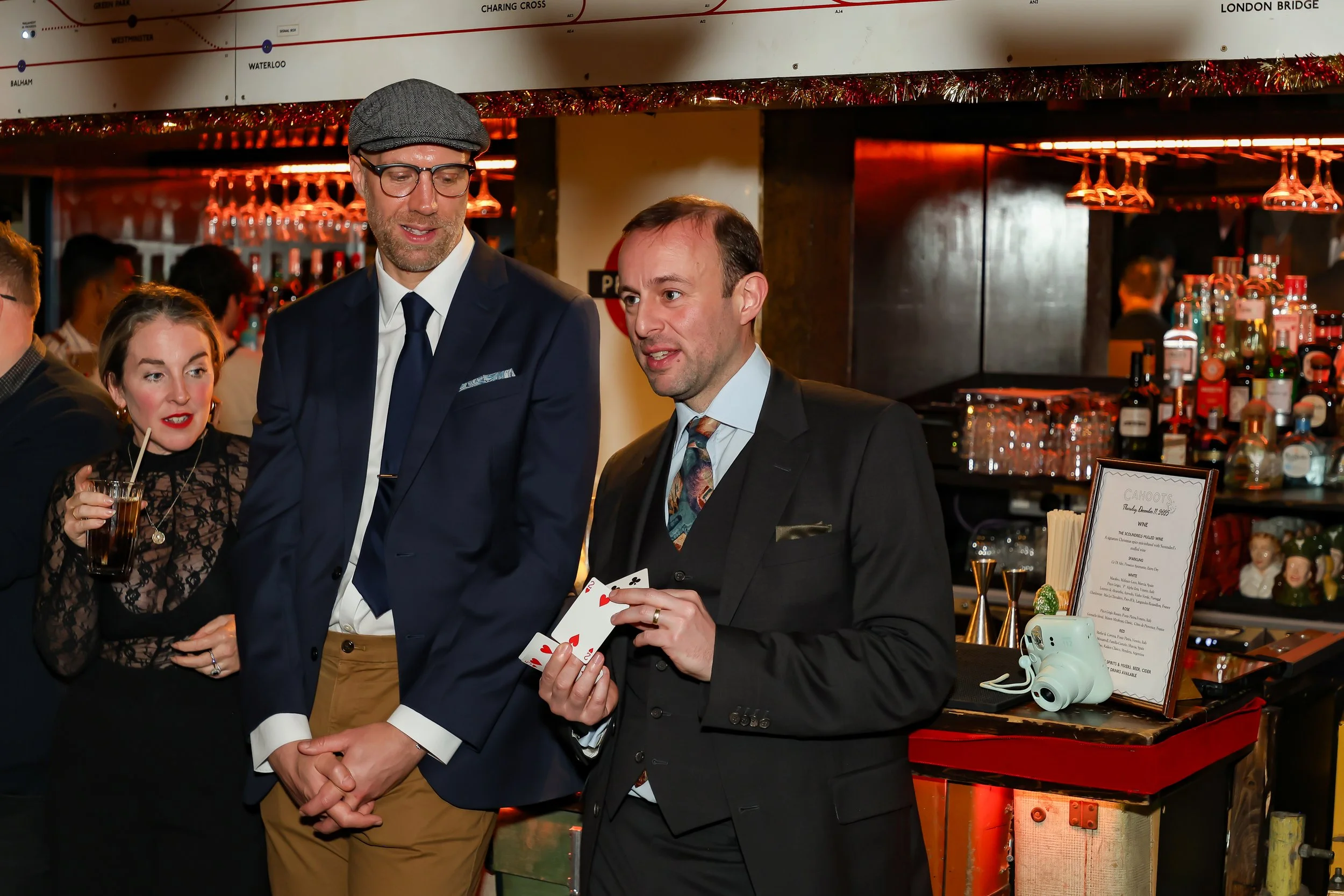 Magician performing walk-around magic for guests at reception.