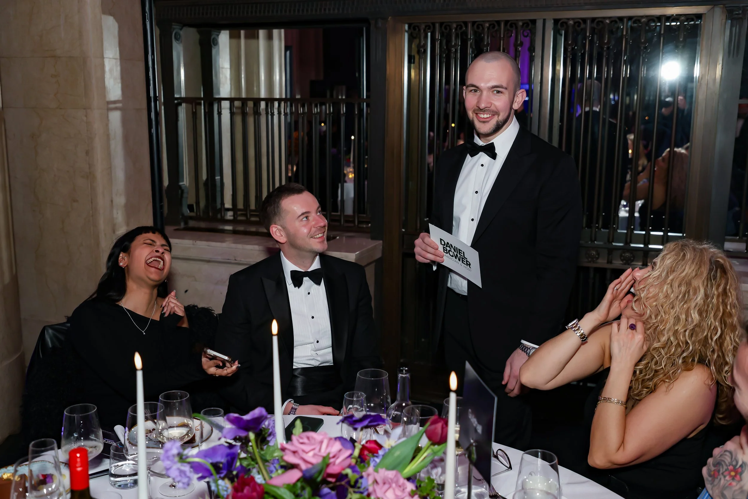 Table-side magic performance delighting guests during a corporate dinner.