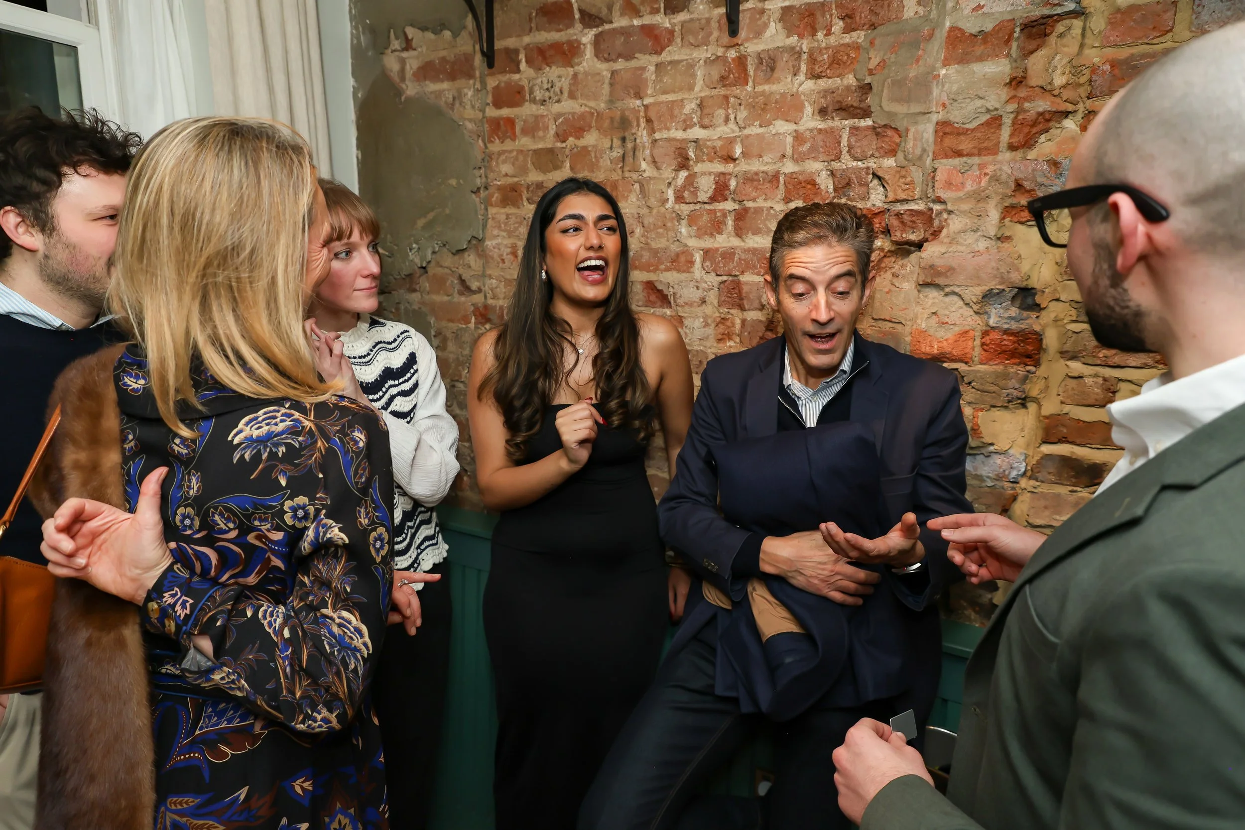 Corporate guests enjoying and applauding live entertainment at the reception.