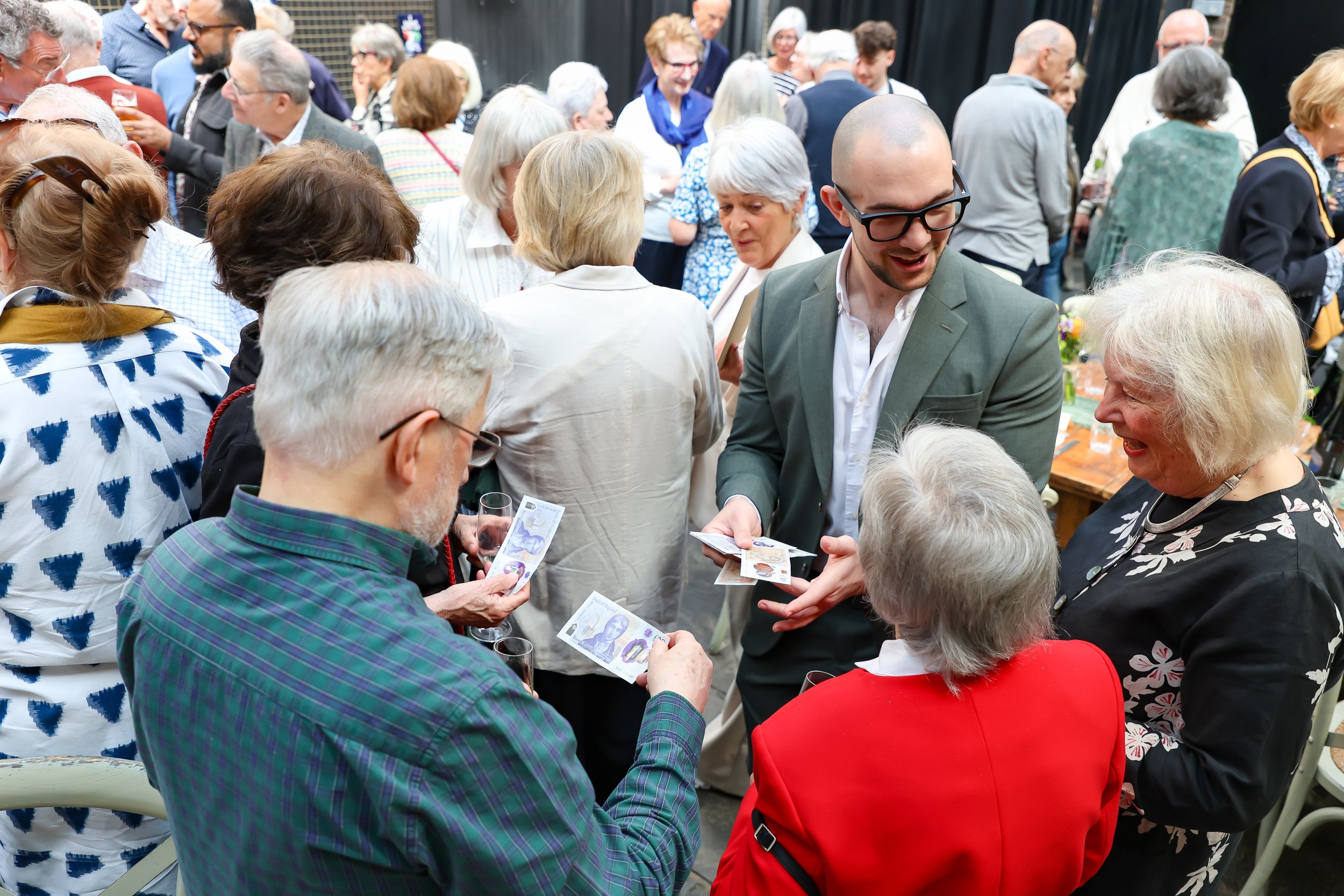 Magician with his card trick. 2026-May 3 Rhoda & Baruch Golden Wedding Anniversary. 