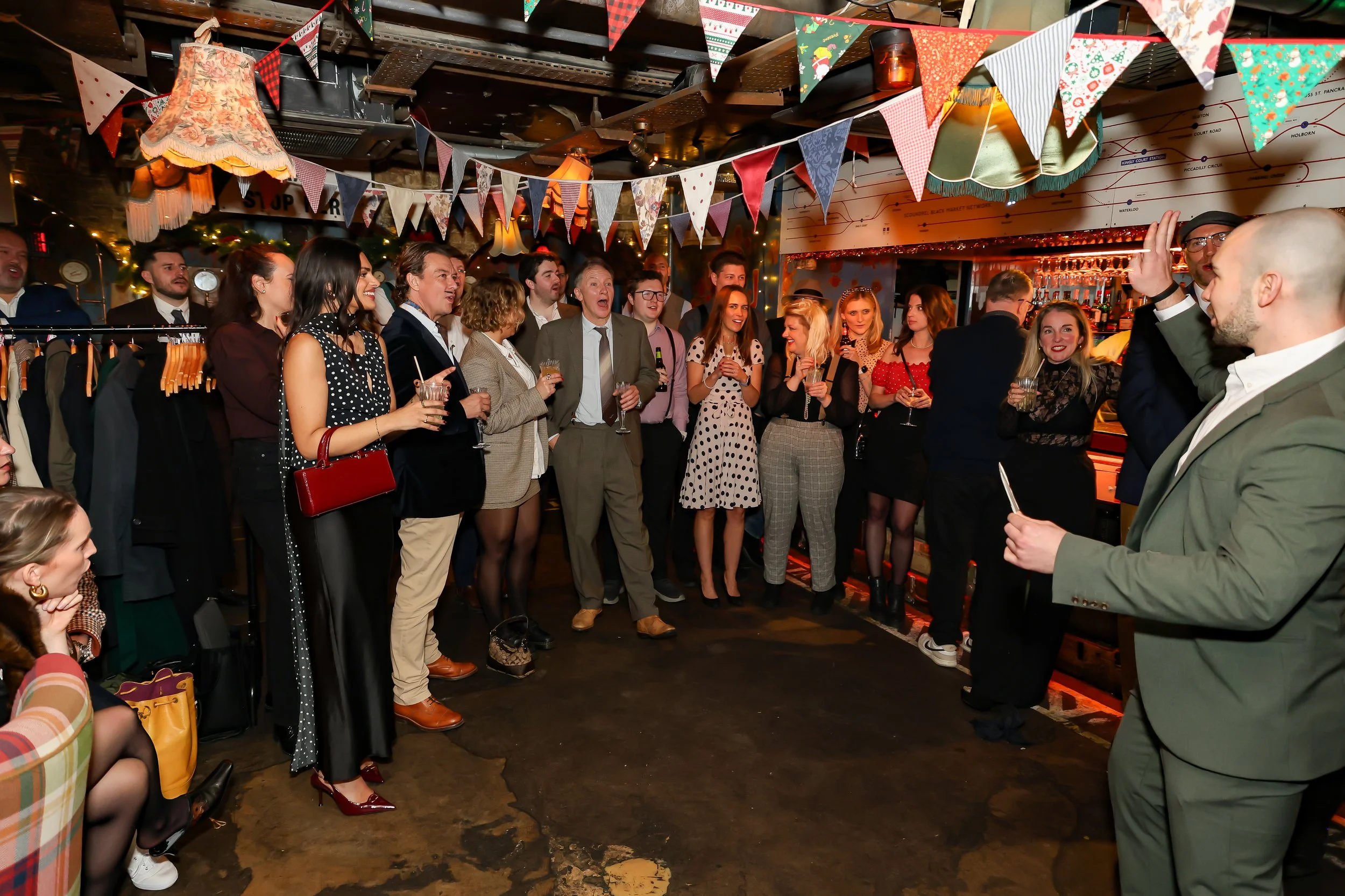 Guests closely watching a professional magic performance by a London-based magician.