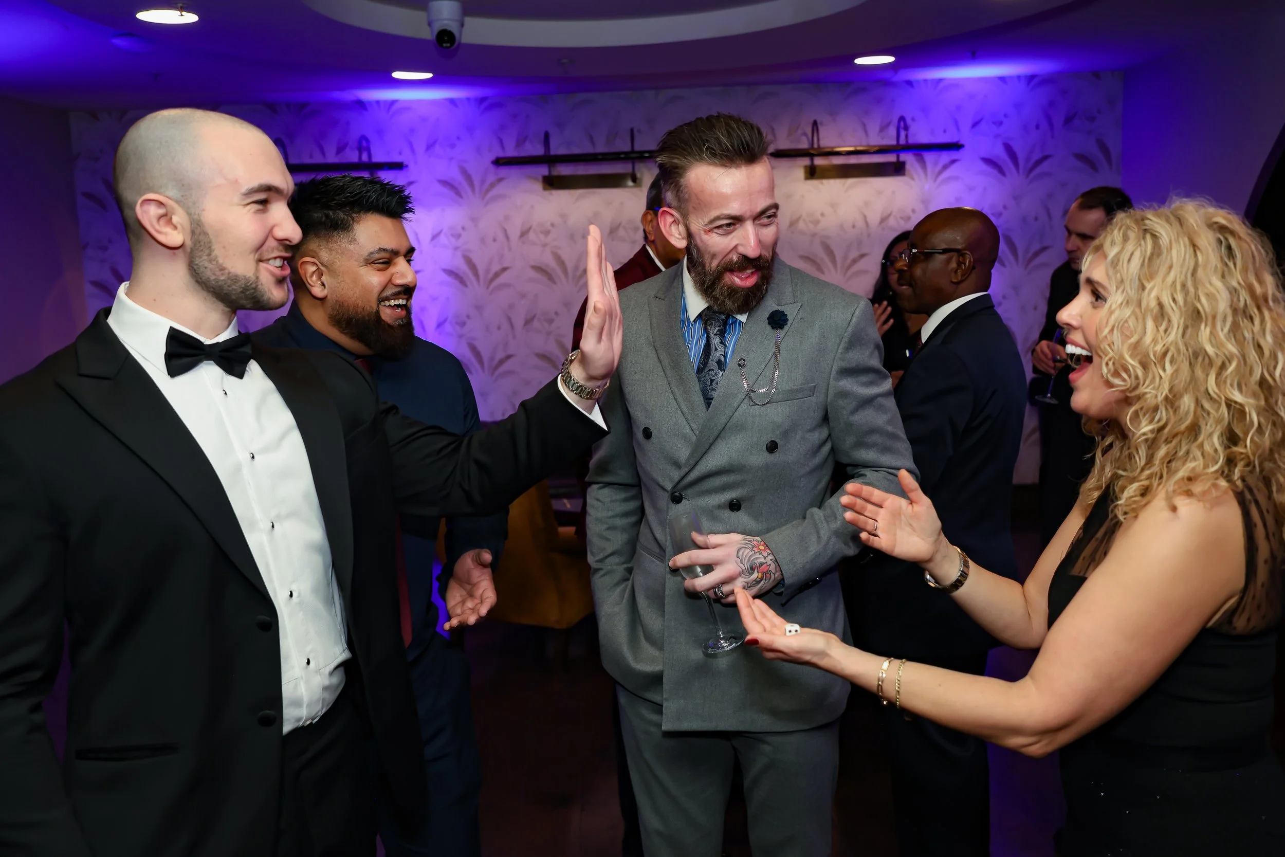 Magician captivating corporate employees to amaze with a close-up trick routine.