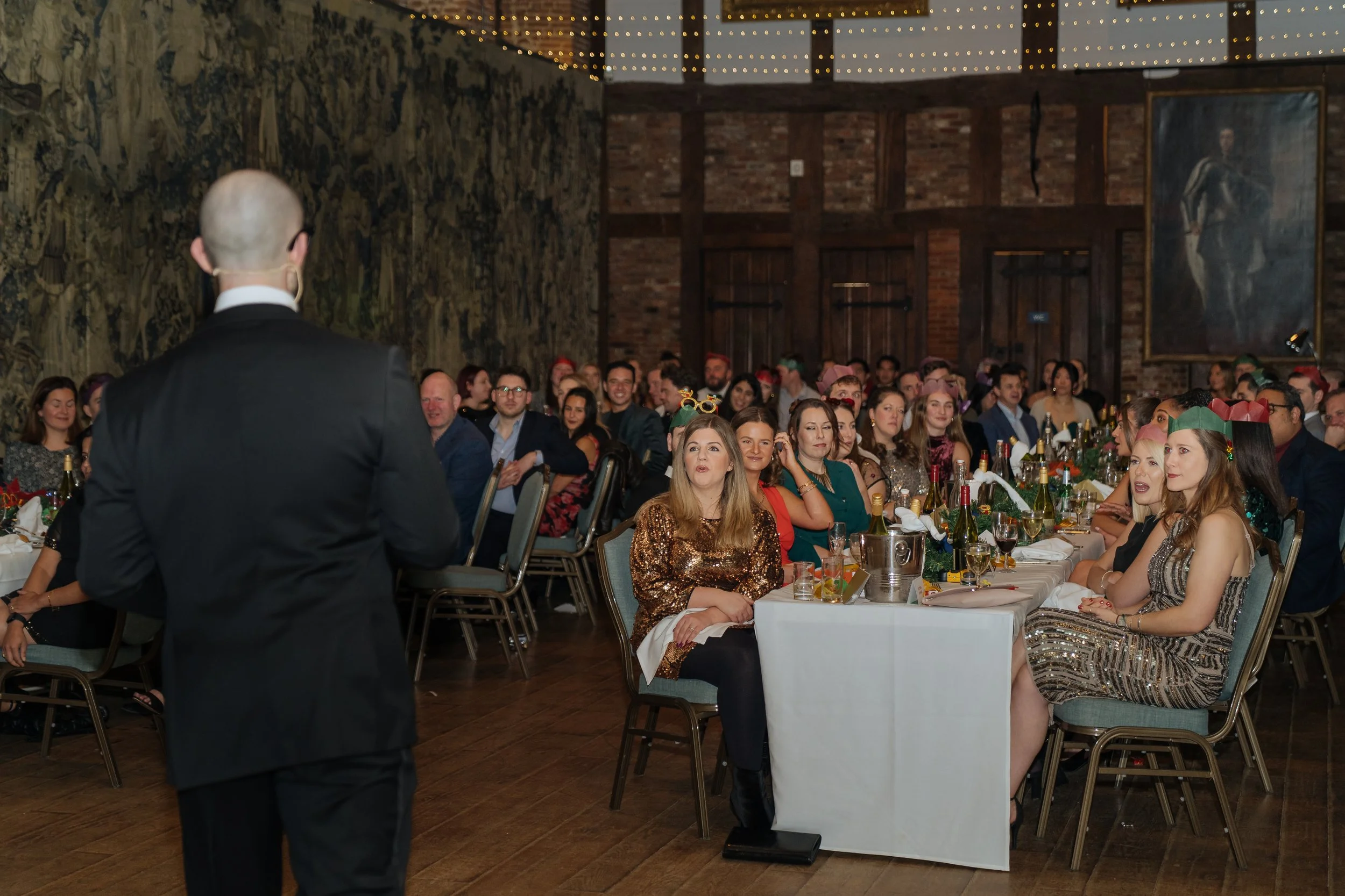 Corporate magician entertaining a full room of guests during a gala dinner.