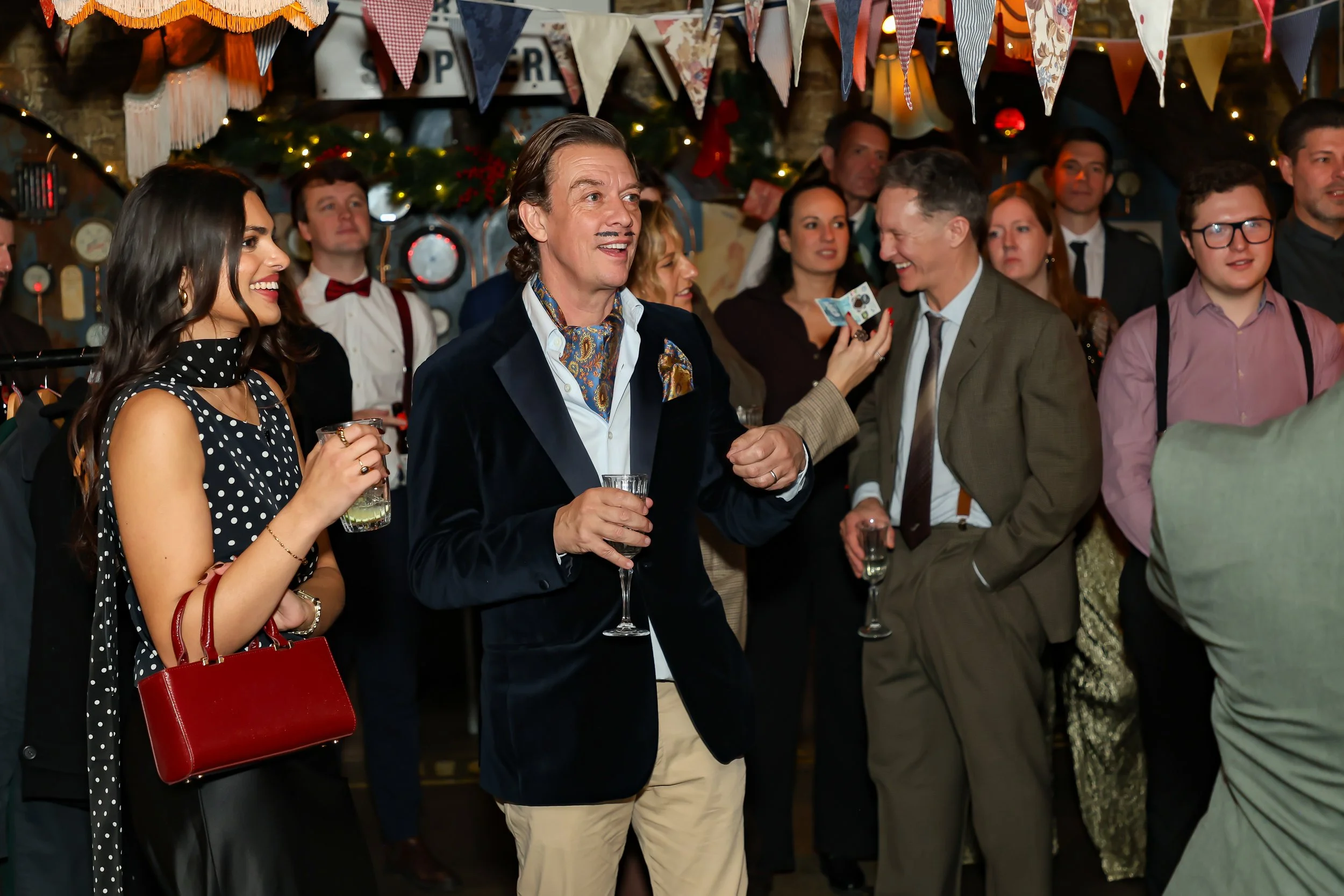 Magician performing walk-around magic for guests at reception.