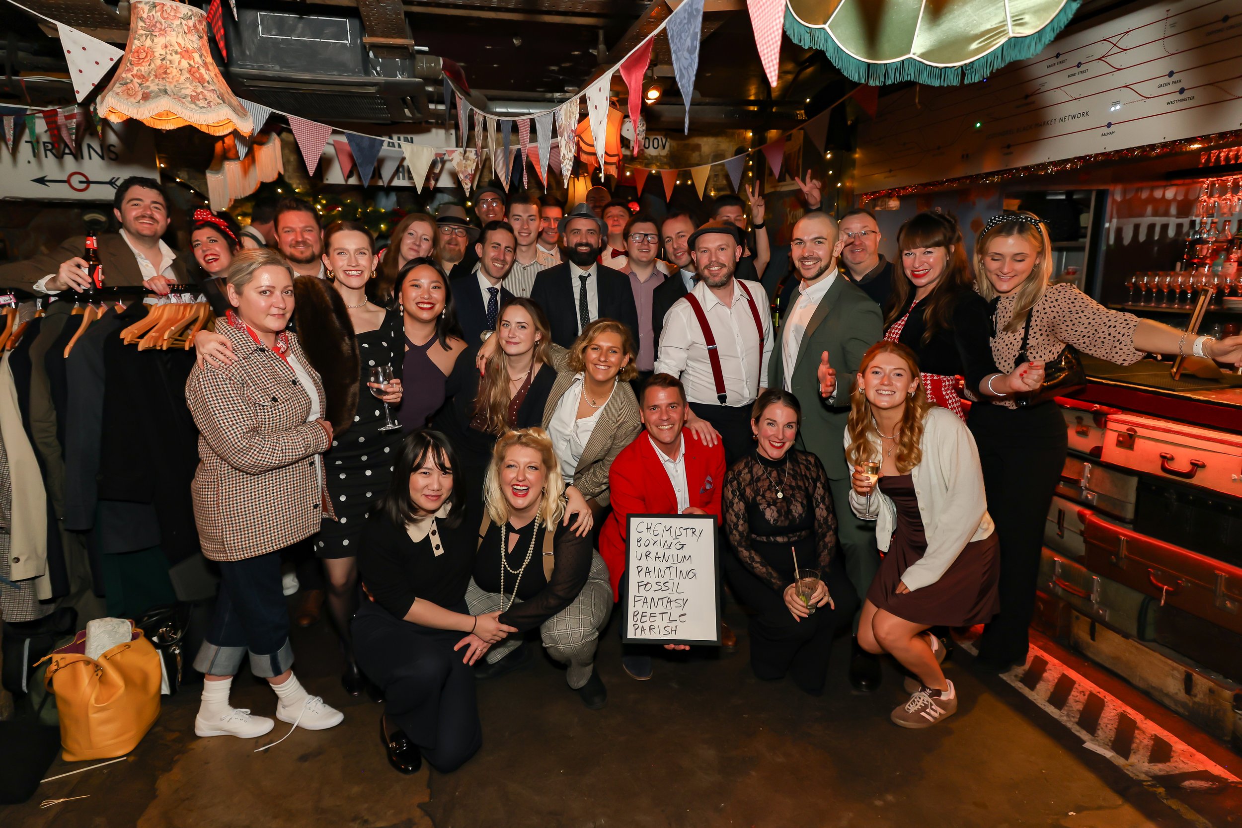 Corporate magician posing with company team during a corporate event.