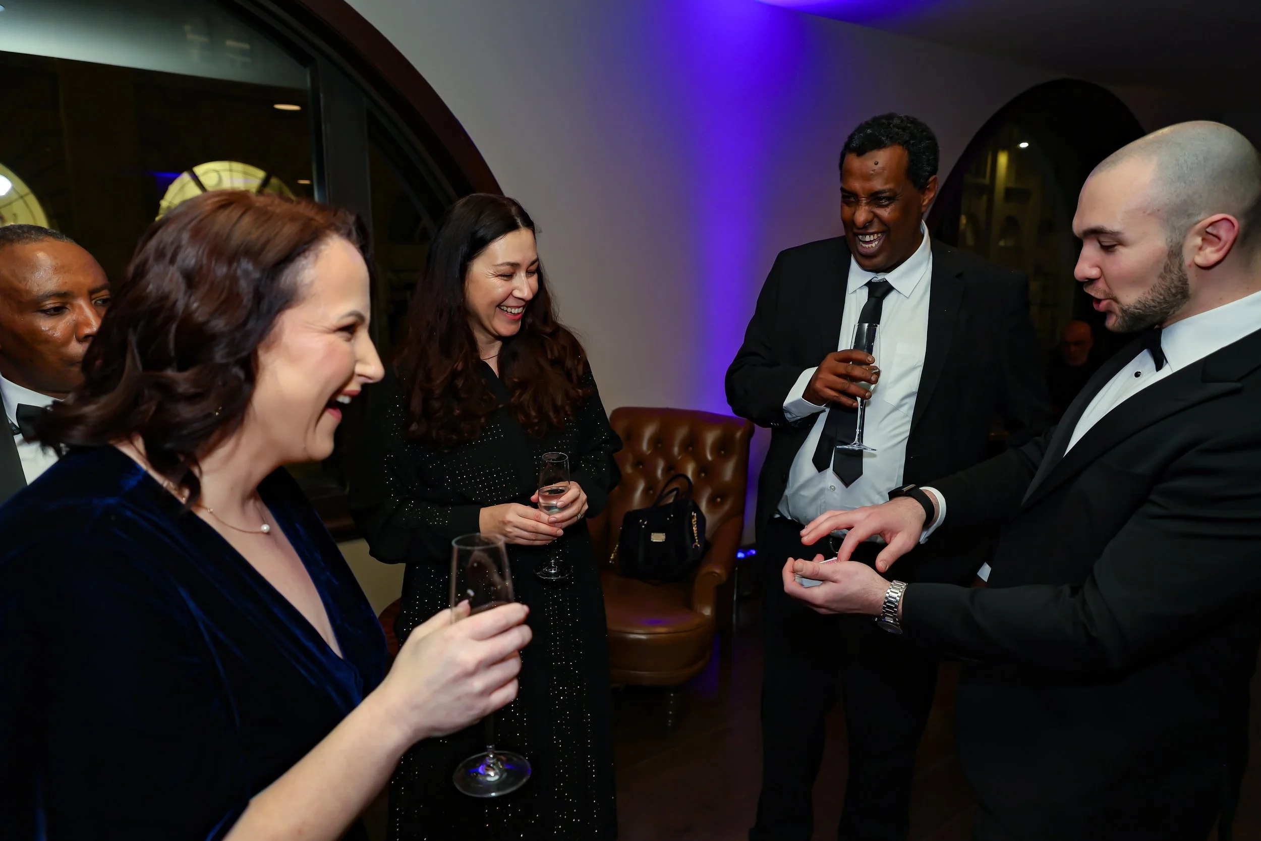 Interactive card magic session with corporate associates.