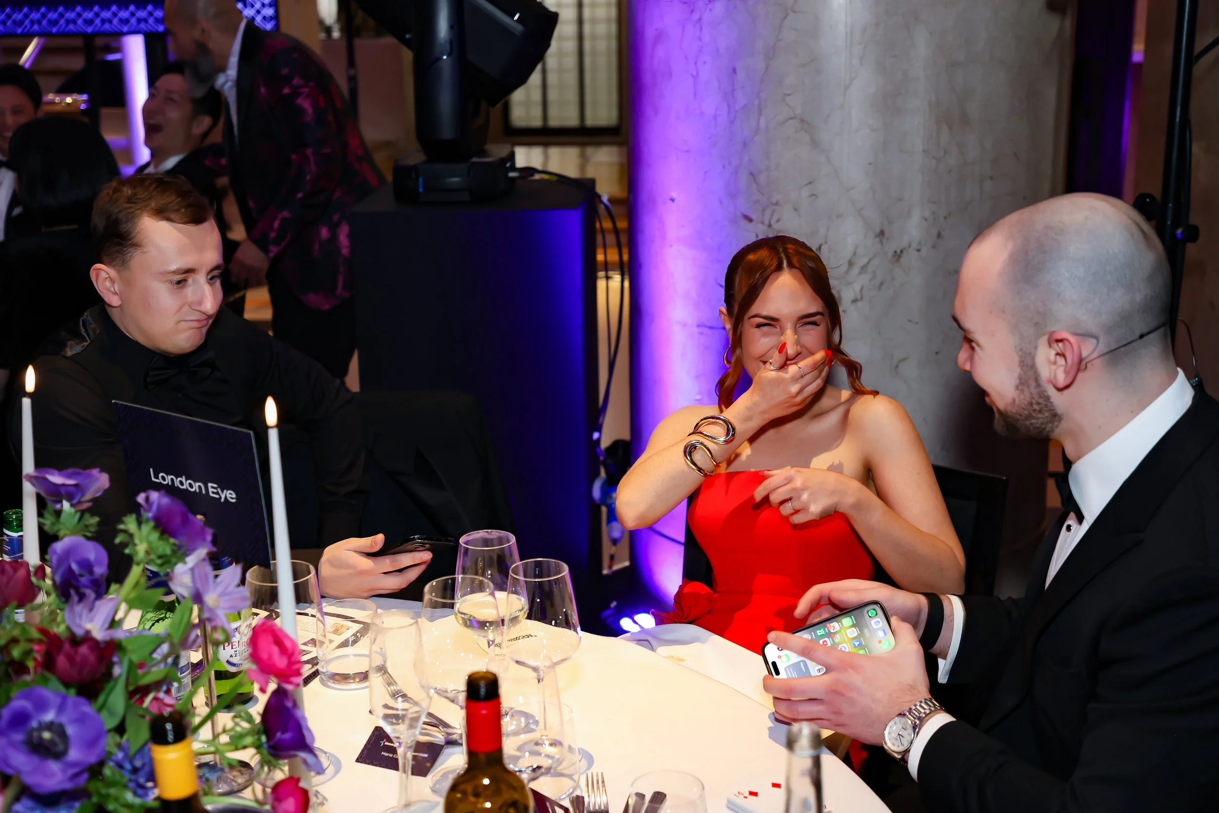 A magician interacting directly with guests, performing magic at the table.