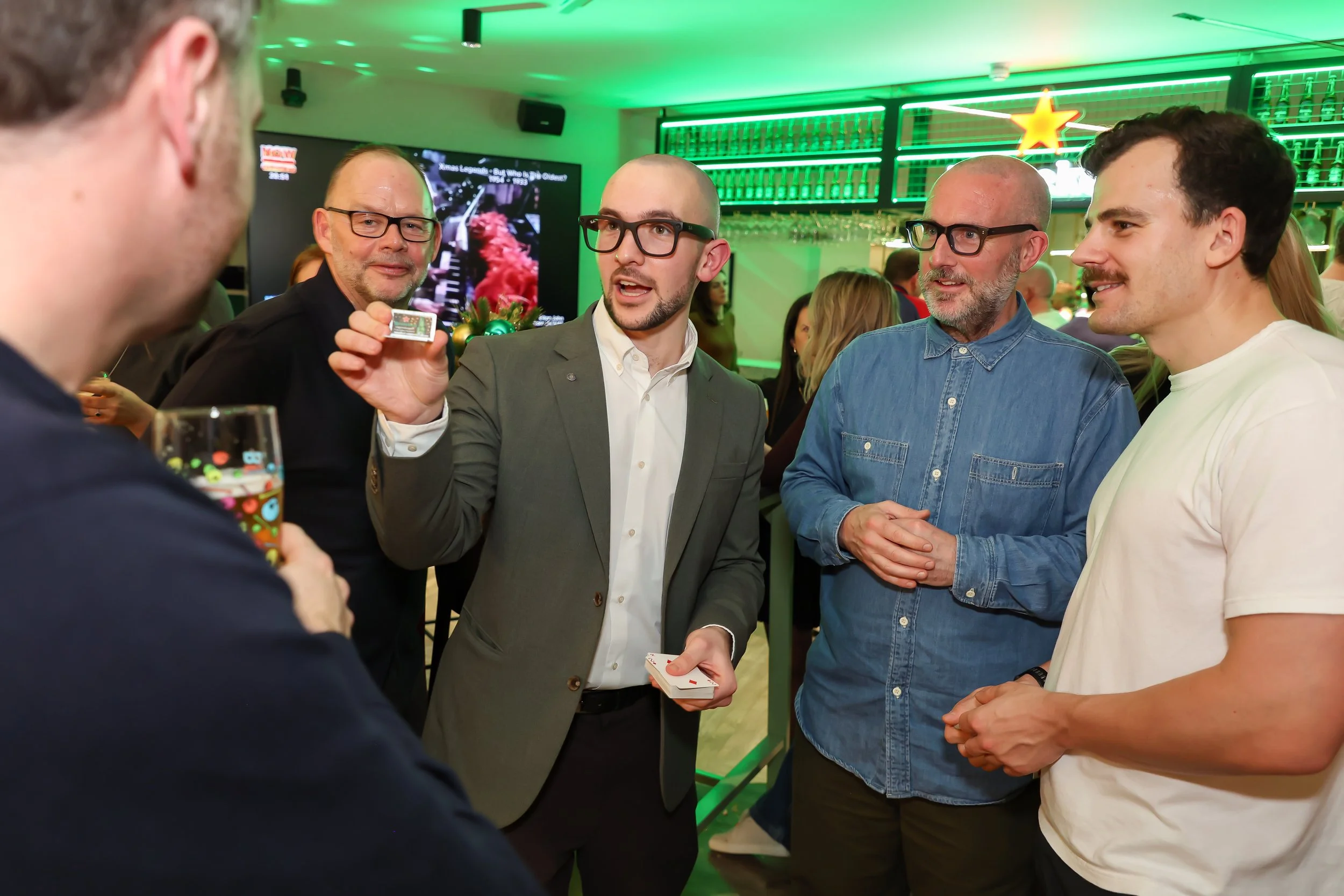 Close-up card magic leaves corporate guests amazed.