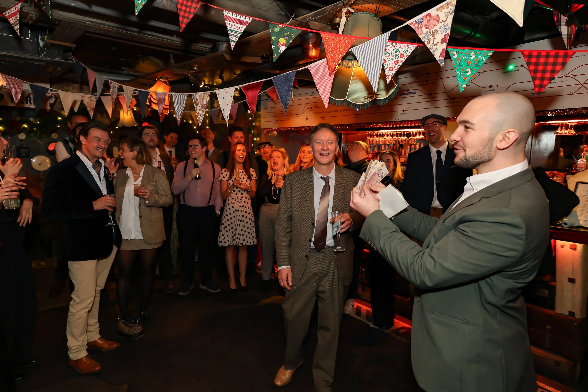 Magician performing walk-around magic for guests at reception.