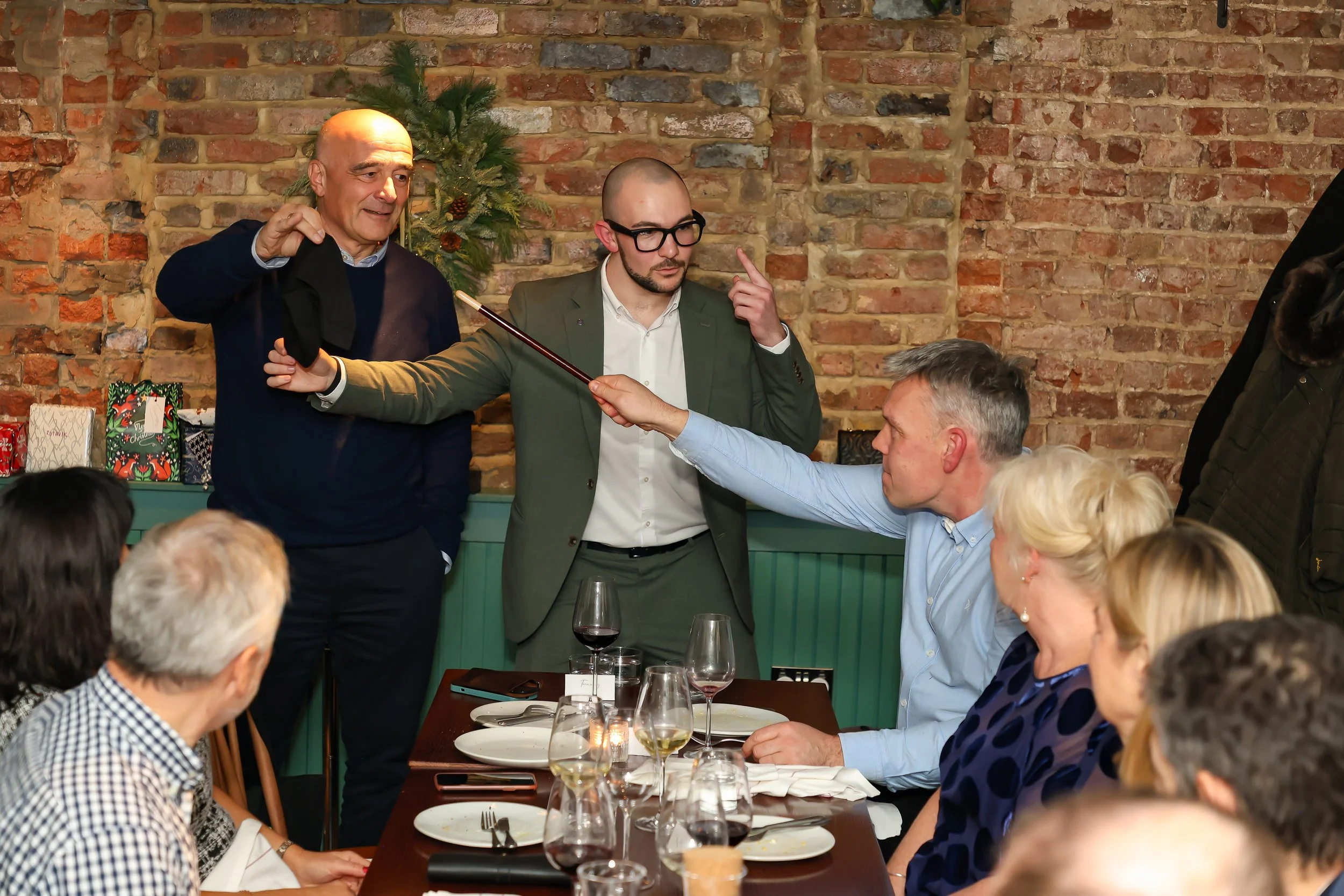 Interactive illusion magic engaging guests during a live corporate dinner performance.