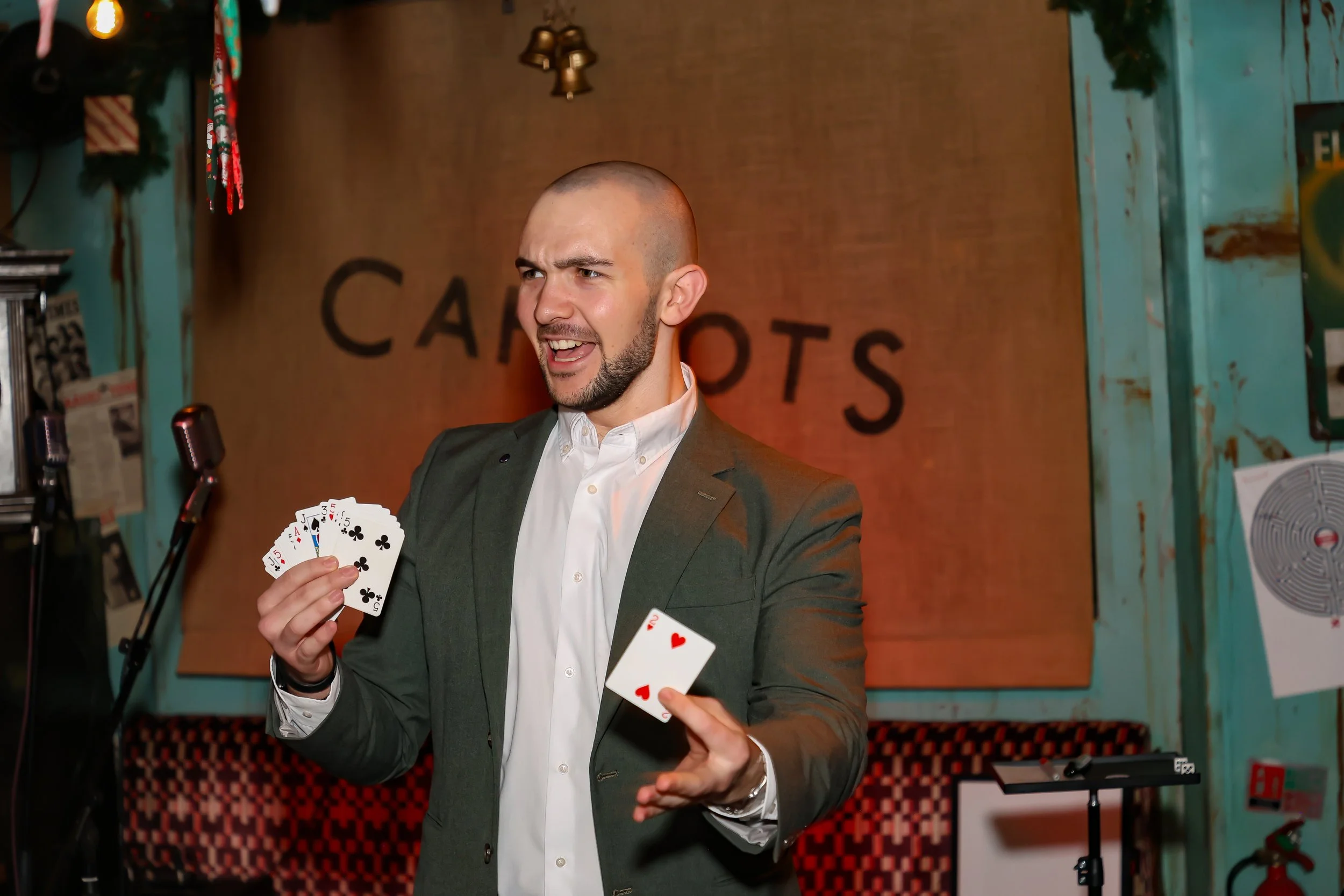 Magician demonstrating sleight-of-hand techniques to the audience.