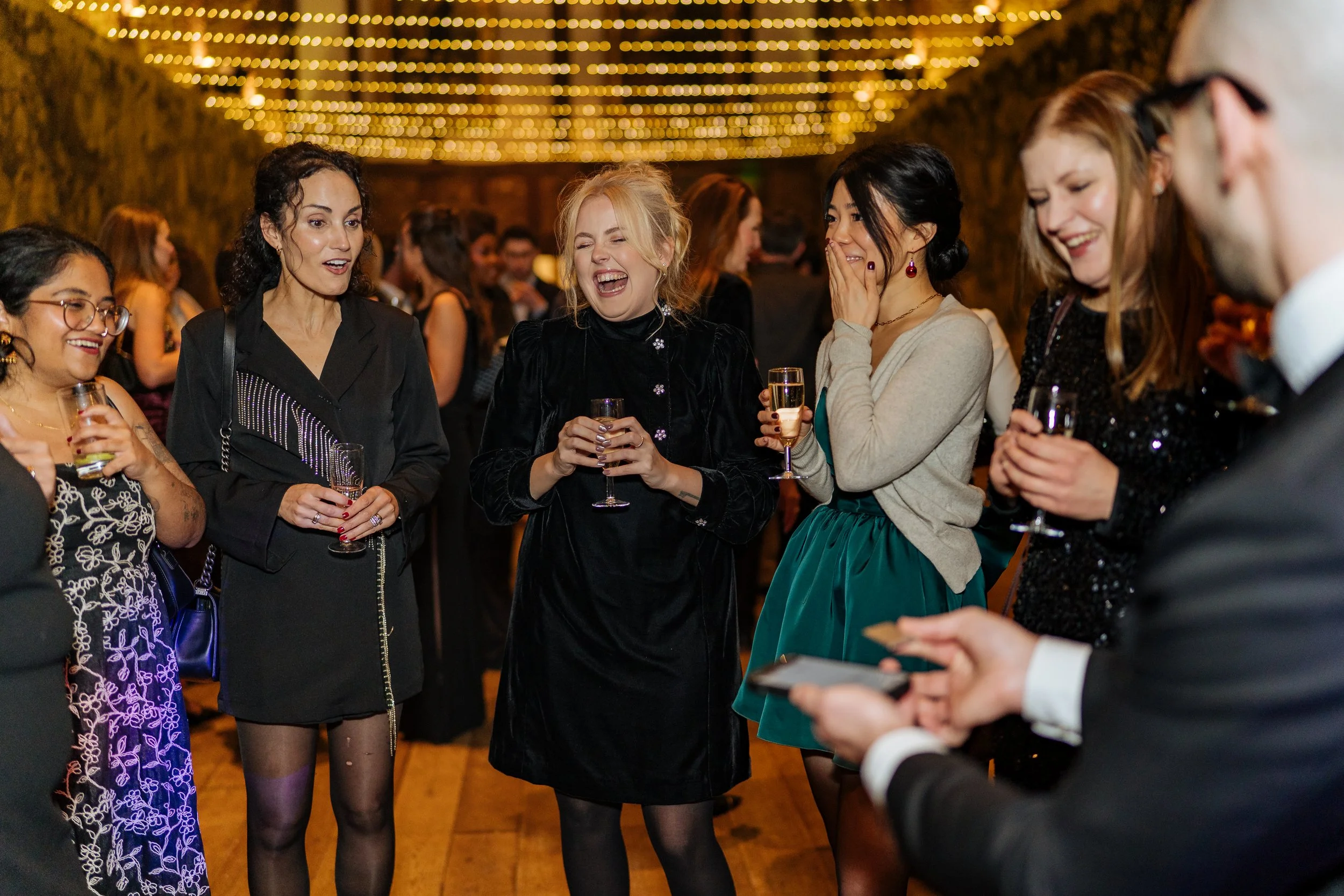 Professional magician entertaining guests at a corporate event reception.