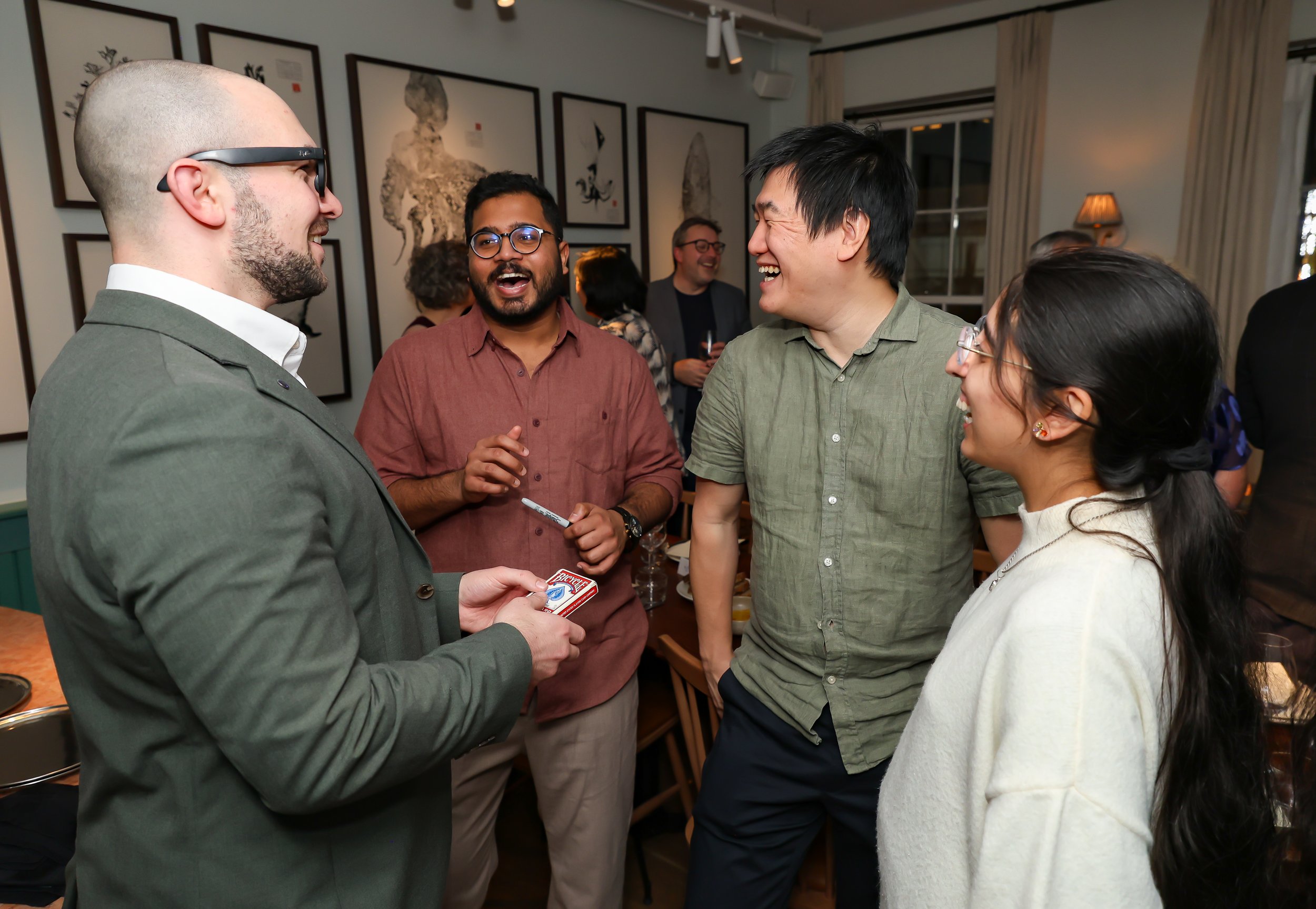 Small-group magic performance engaging guests with shared laughter and amazement.