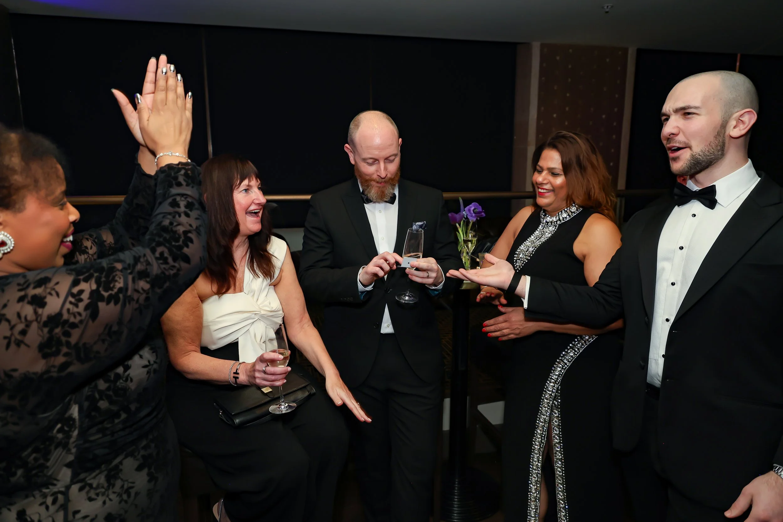 Corporate professionals enjoying with a live performance by the magician during reception.