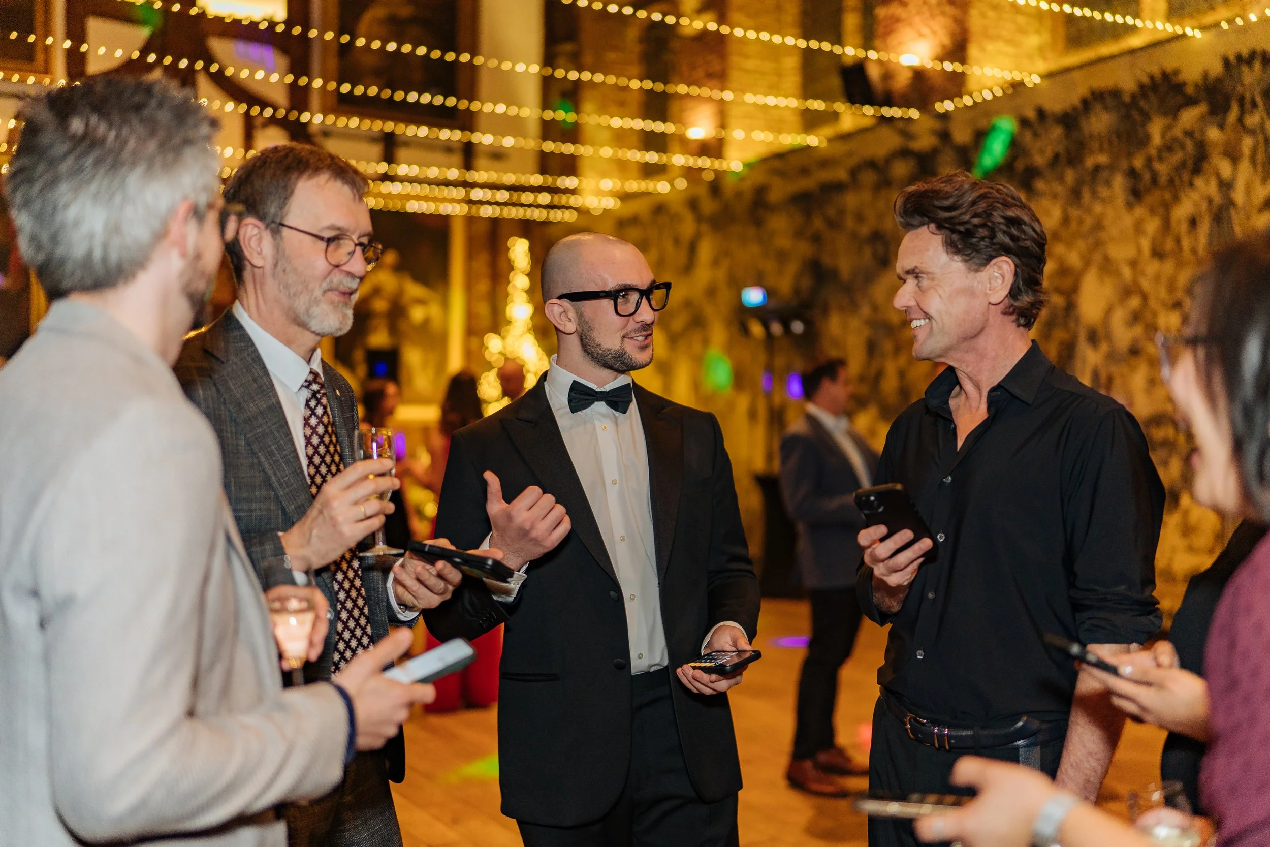 Interactive magician engaging business leaders during a formal company event.