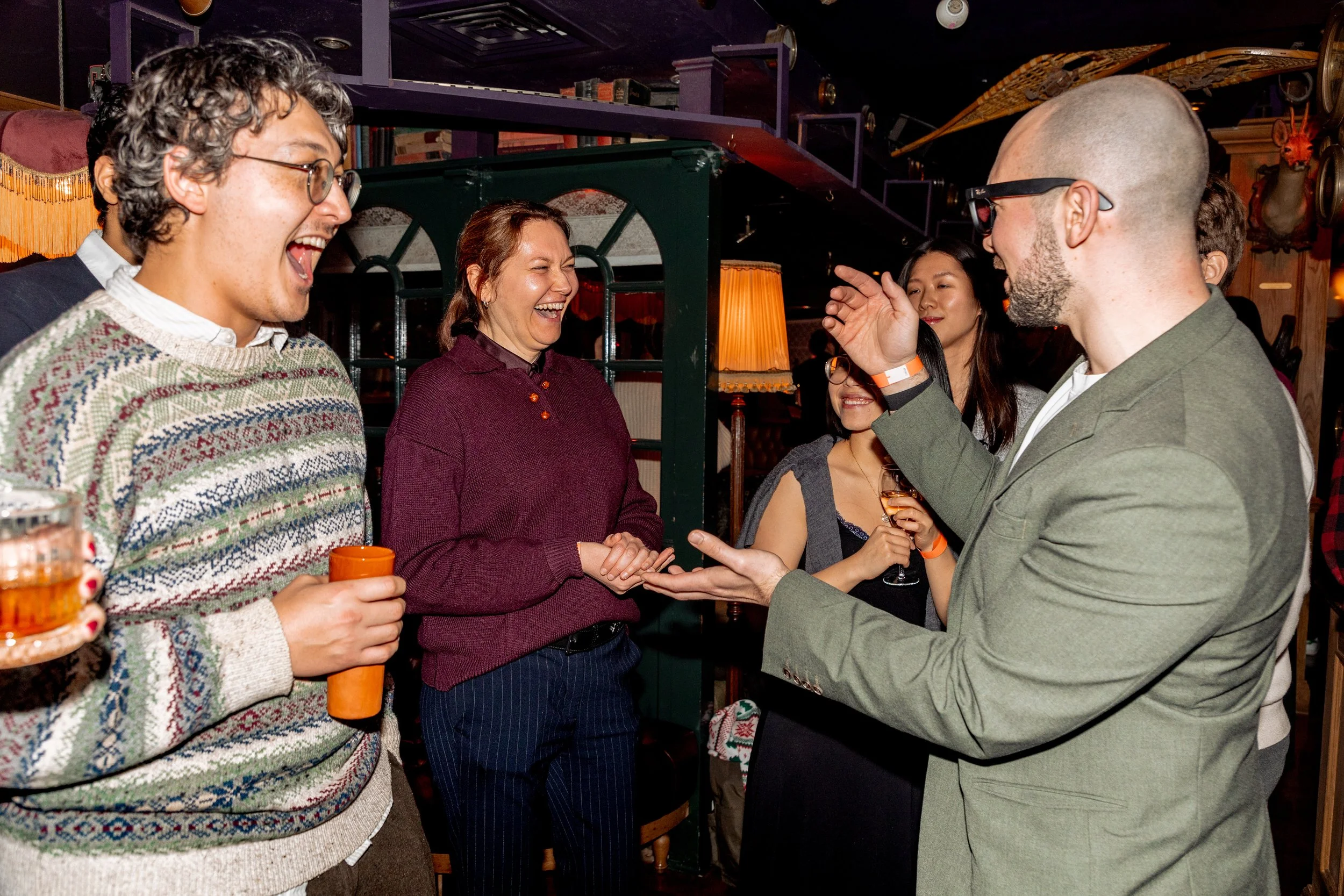 Small group close-up magic during event reception. 