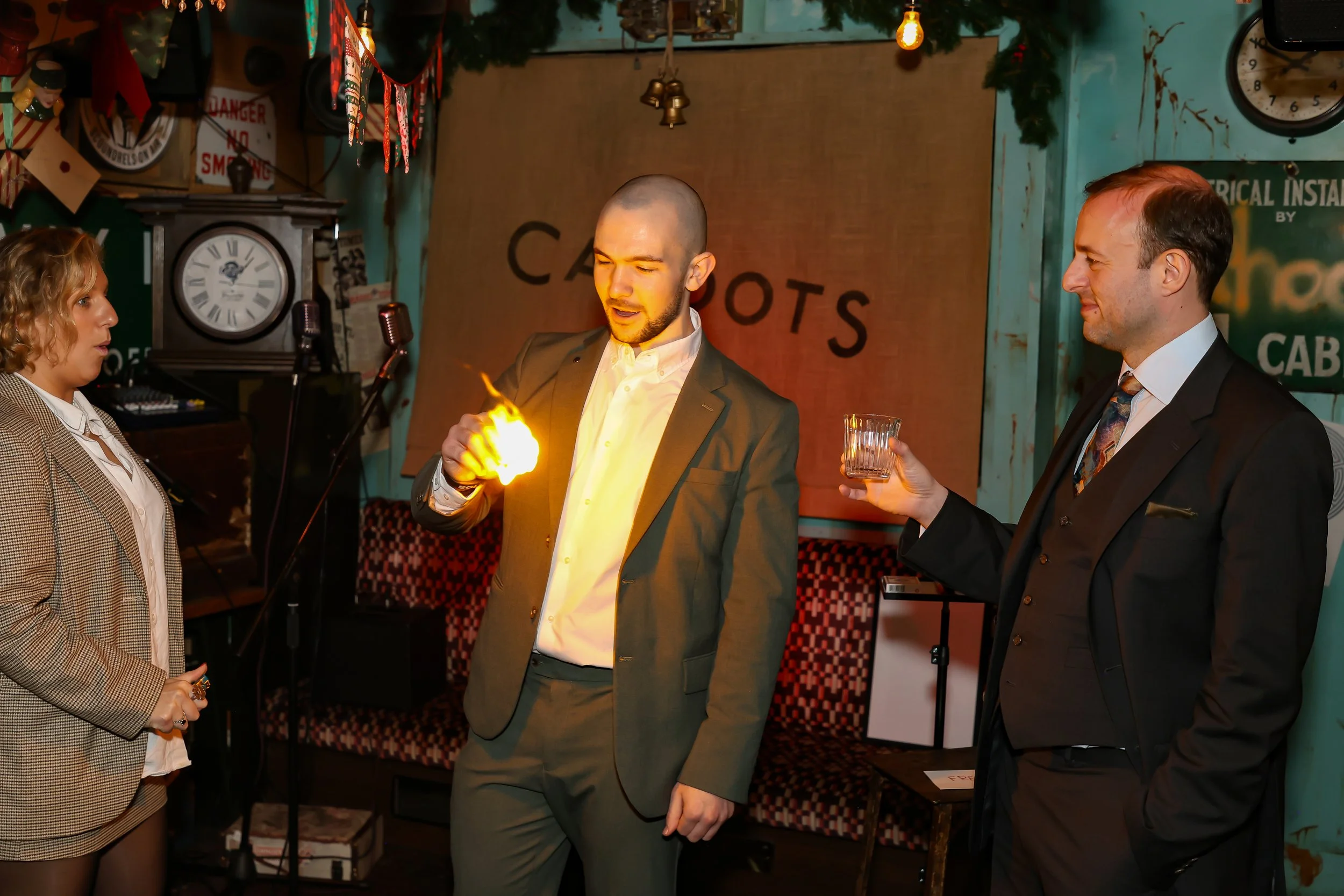 Guests reacting with amazement during a fire and ice magic trick at the event reception.