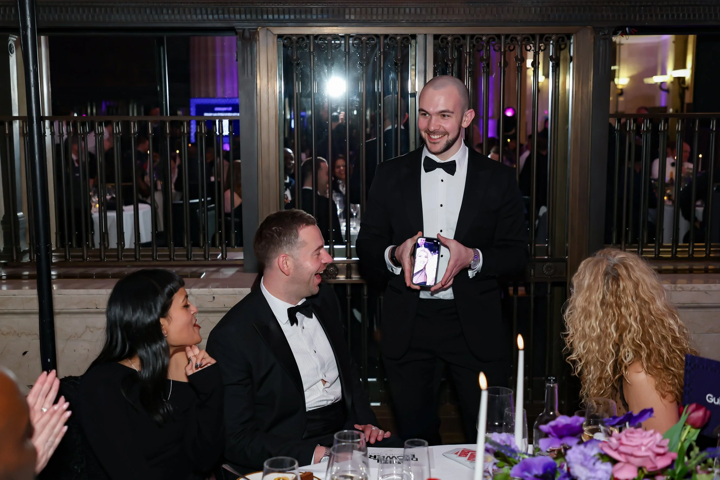 A magician performing intimate close-up tricks for guests at their table.
