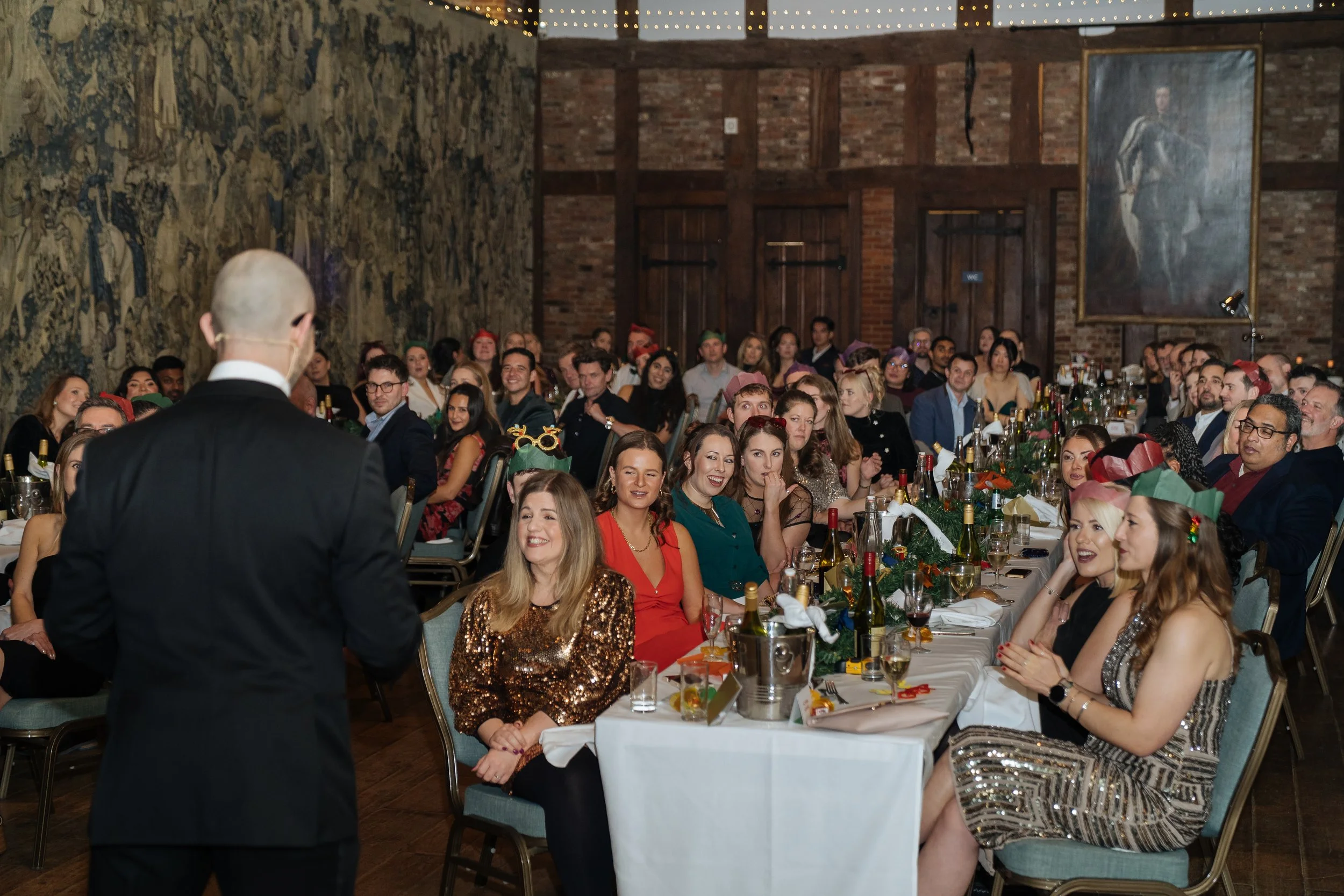 Magician entertaining corporate attendees during a formal company gala evening.