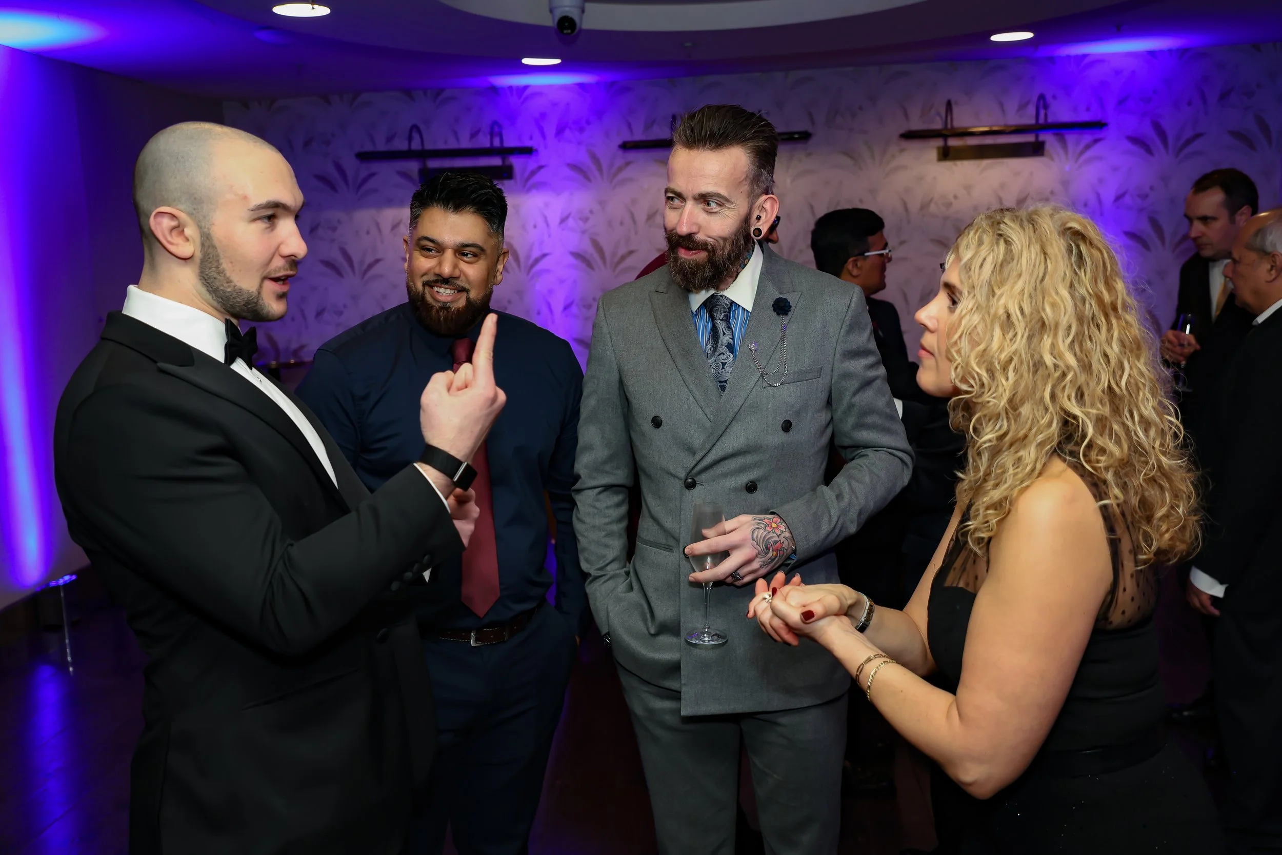 Guests enjoying while engaging magic trick during a corporate function.