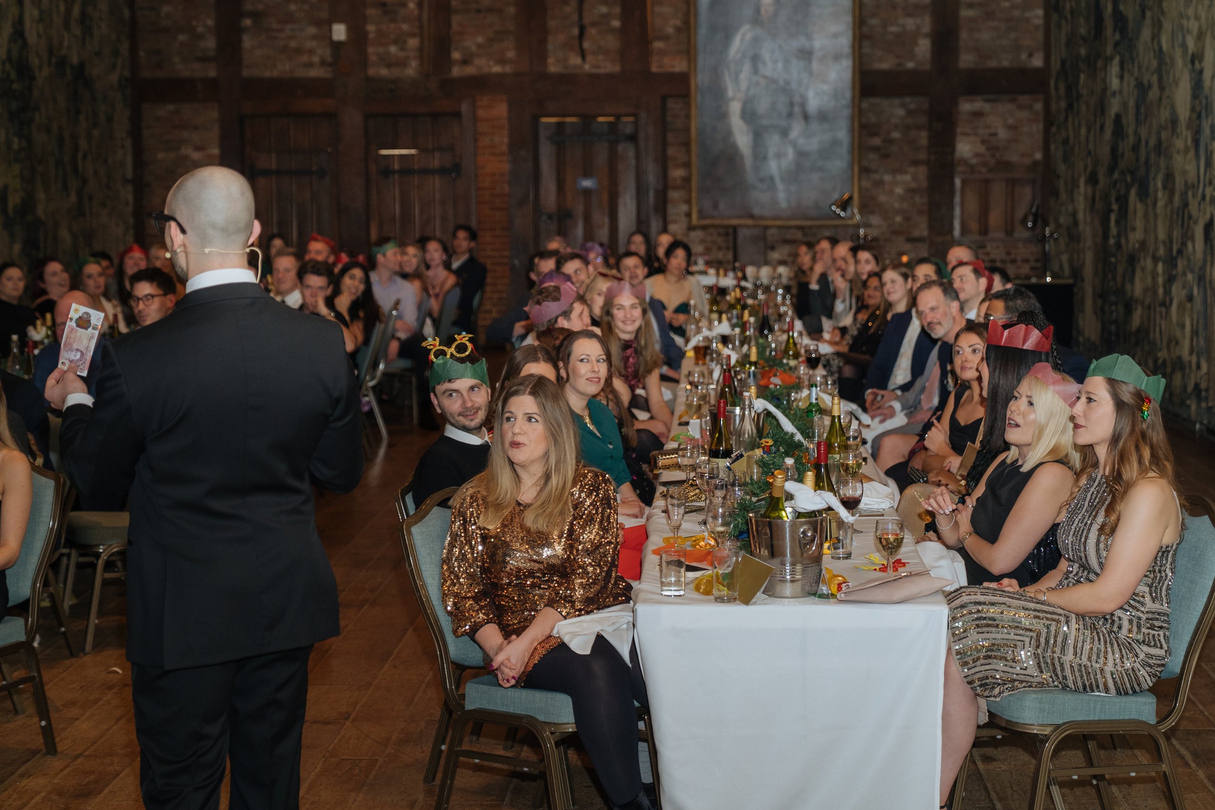 Magician entertaining corporate attendees during a formal company gala evening.