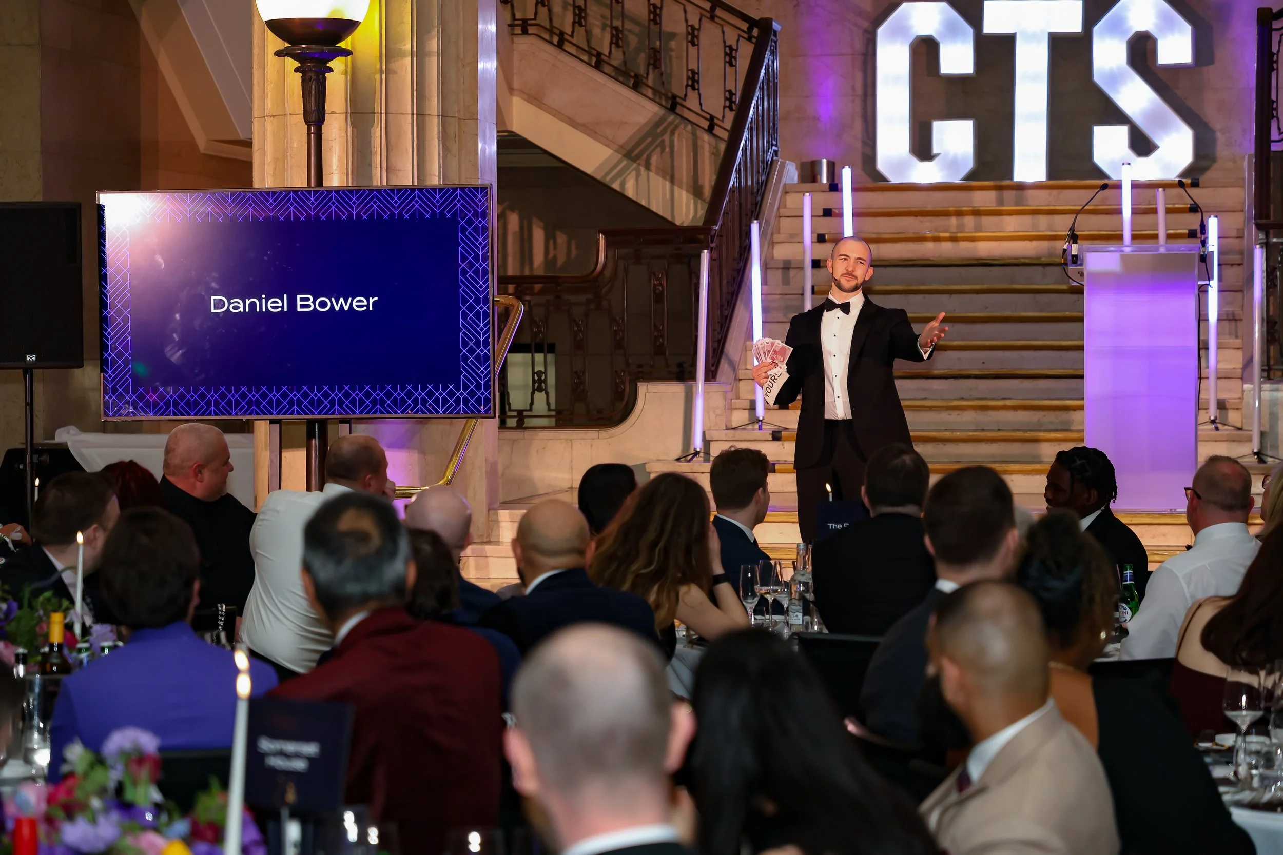 A skilled event host & magician balancing structure and spontaneity to keep the room energised and focused.