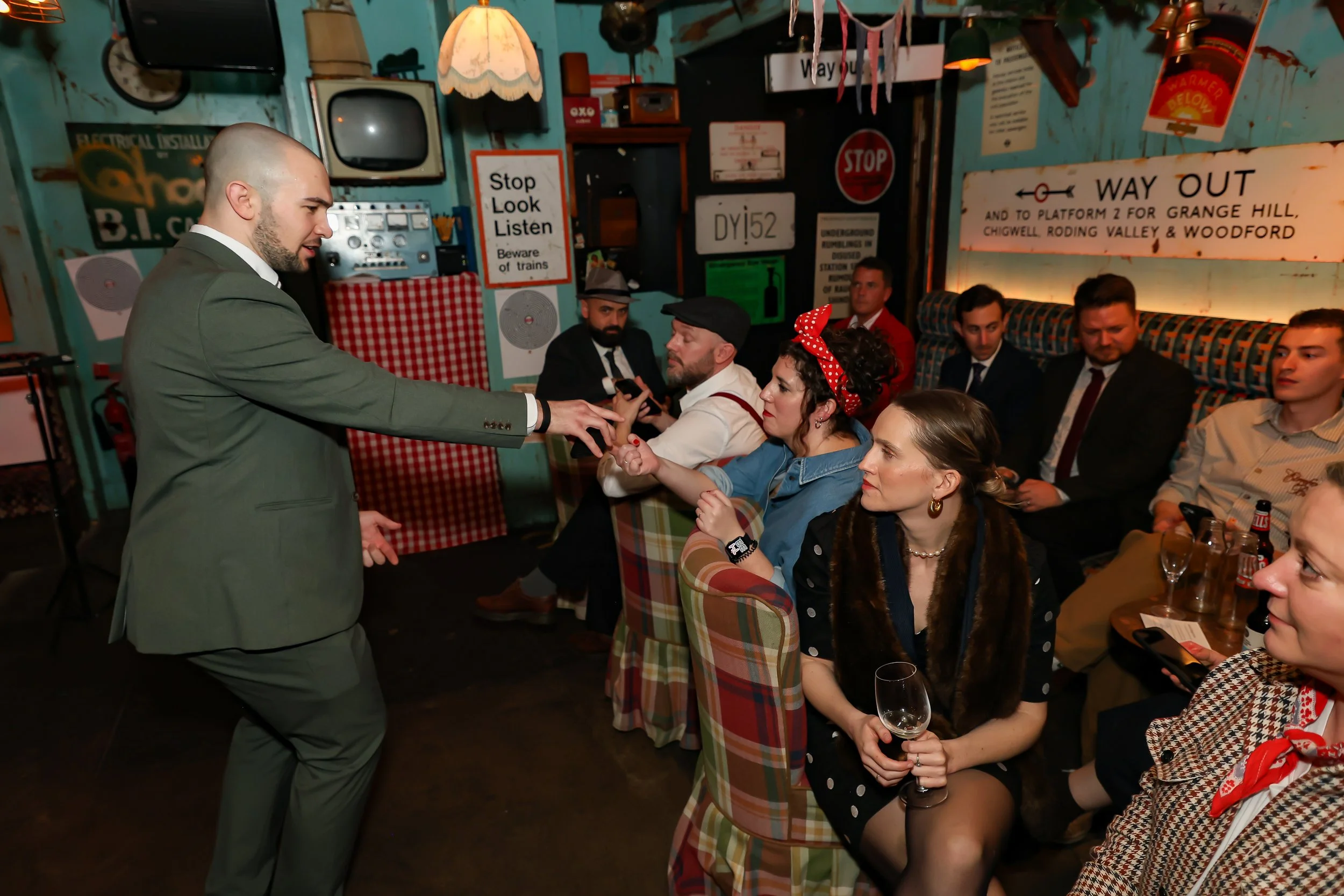 Magician involving the audience in interactive illusion magic at a dinner event.