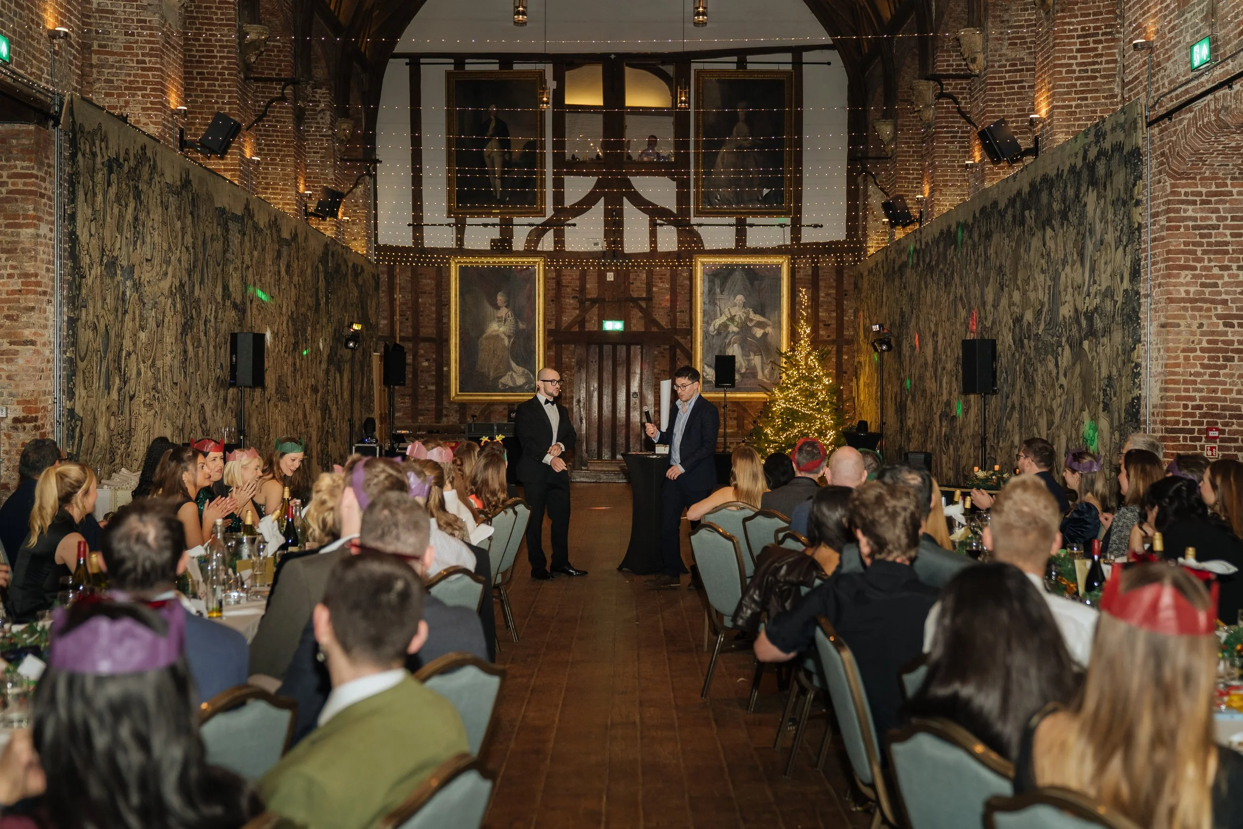 A corporate guest actively participating in a live magic performance, engaging with the magician on stage.