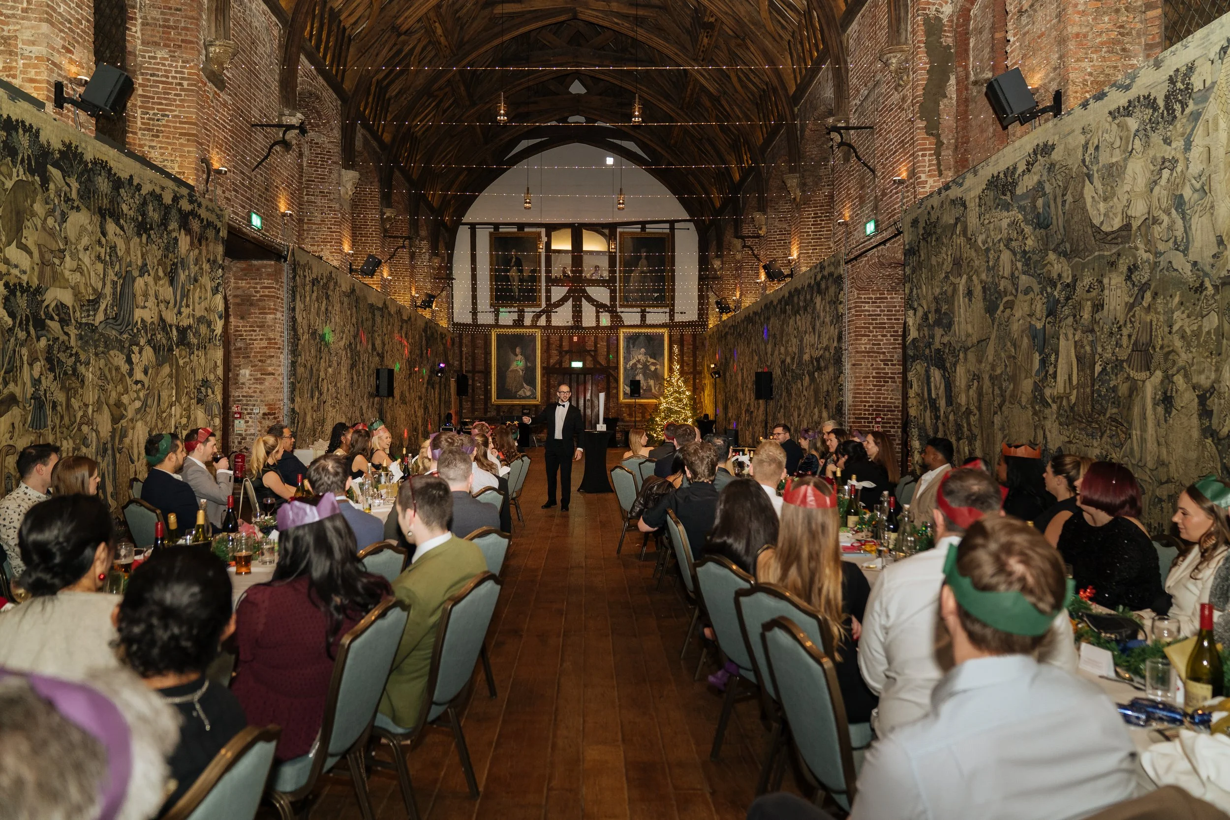 Corporate magician entertaining a full room of guests during a gala dinner.