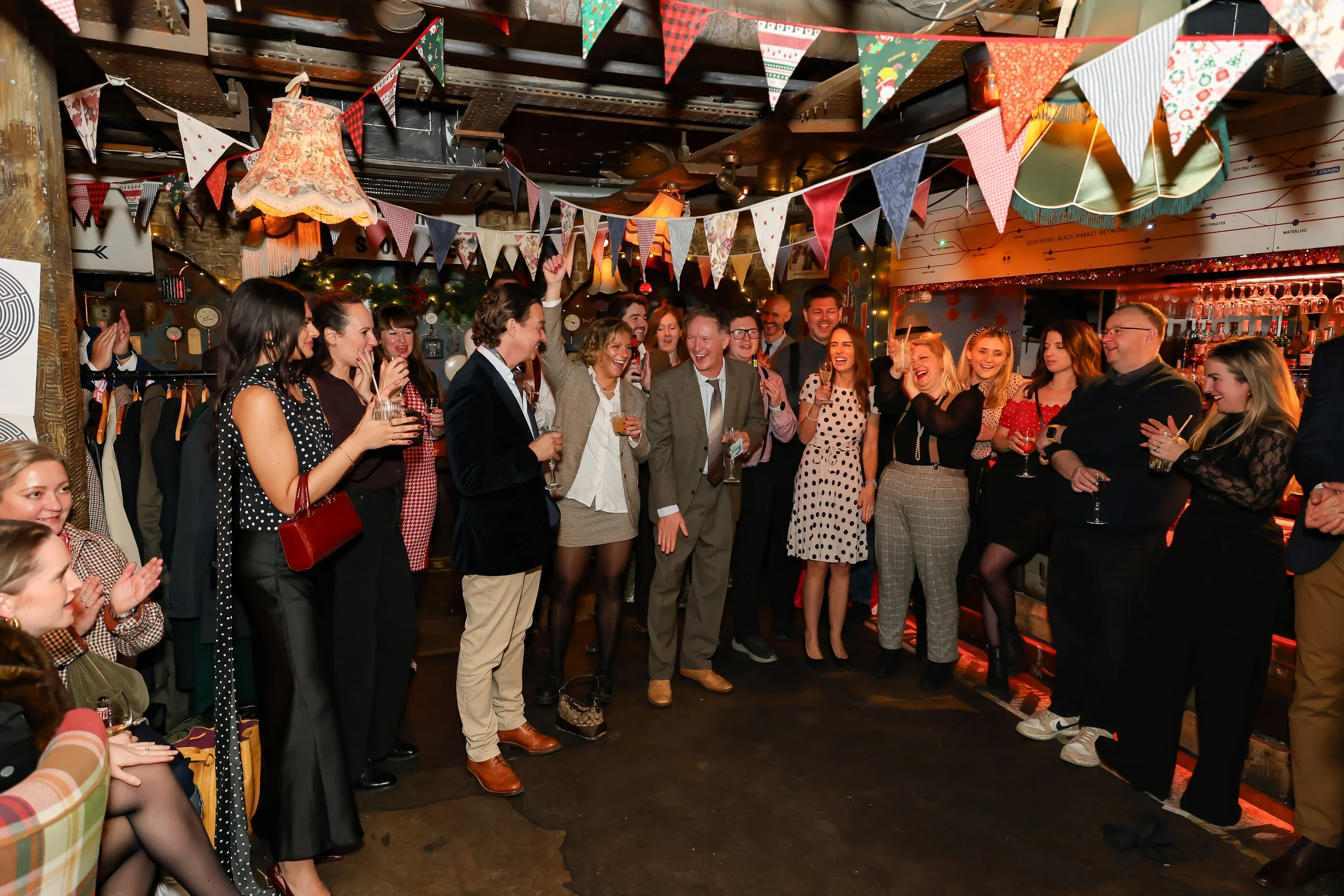 Corporate guests enjoying a close-up magic performance by a London magician.