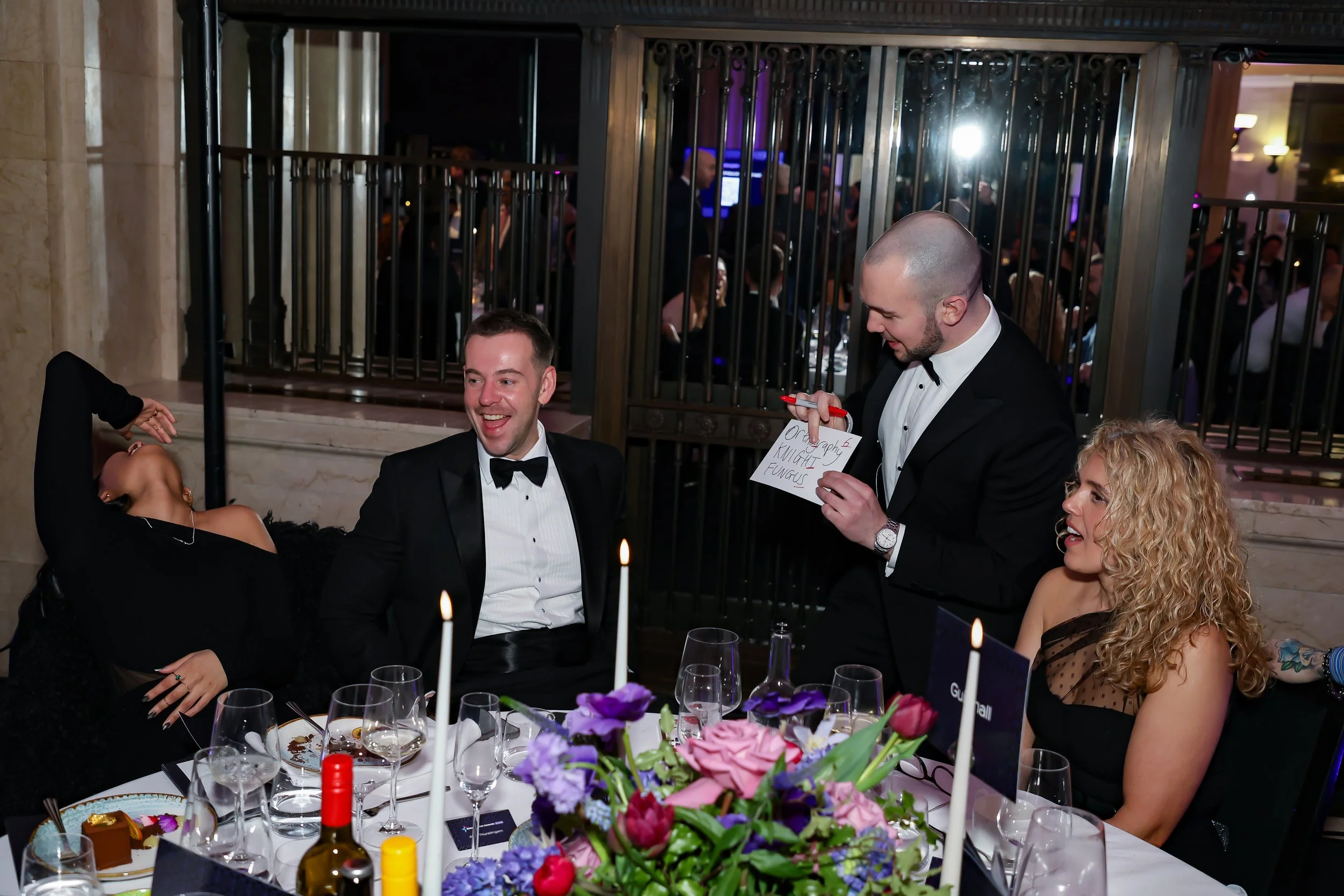 Table-side magic performance delighting guests during a corporate dinner.