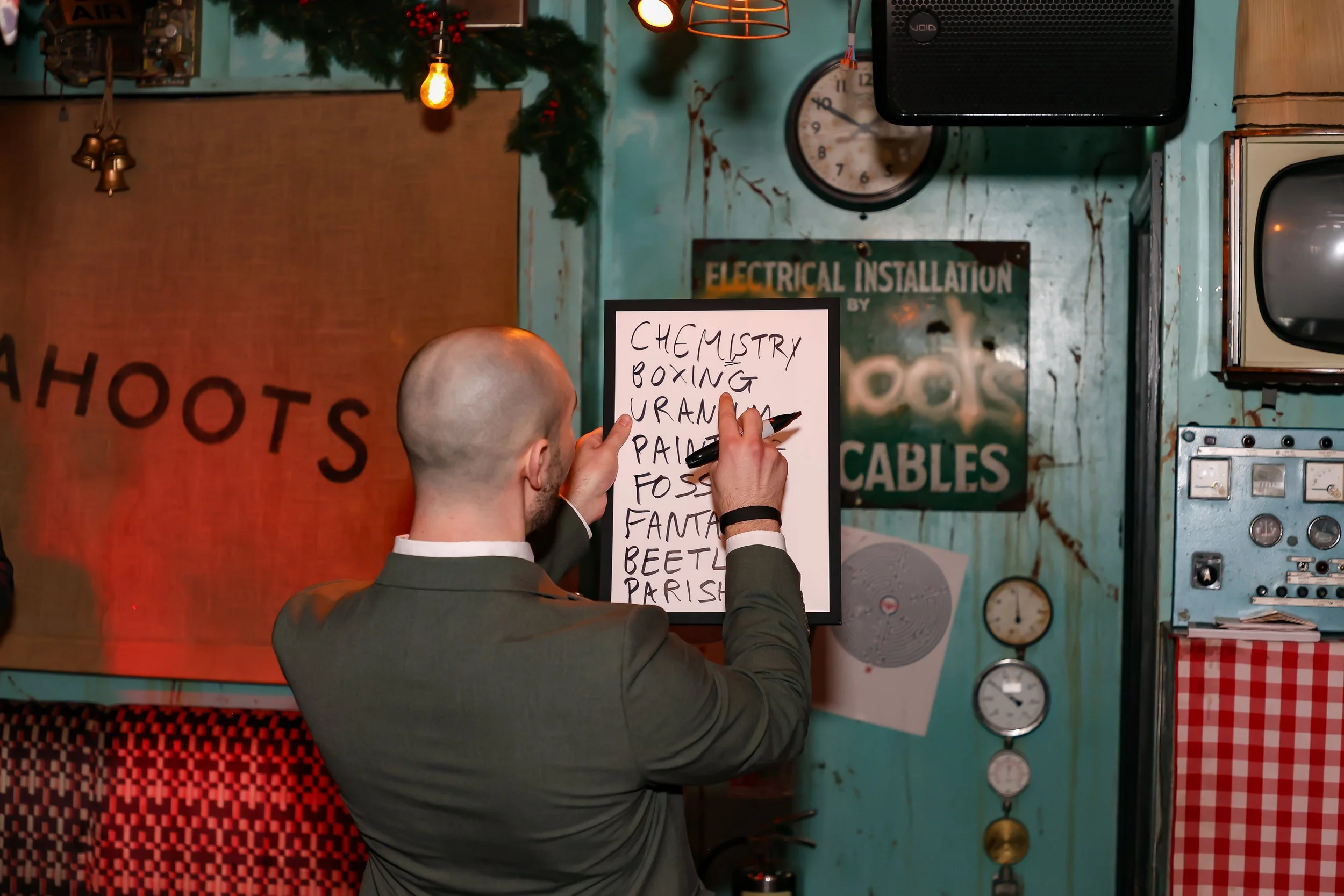 Close-up magician revealing a corporate name created through guest participation during a reception event.