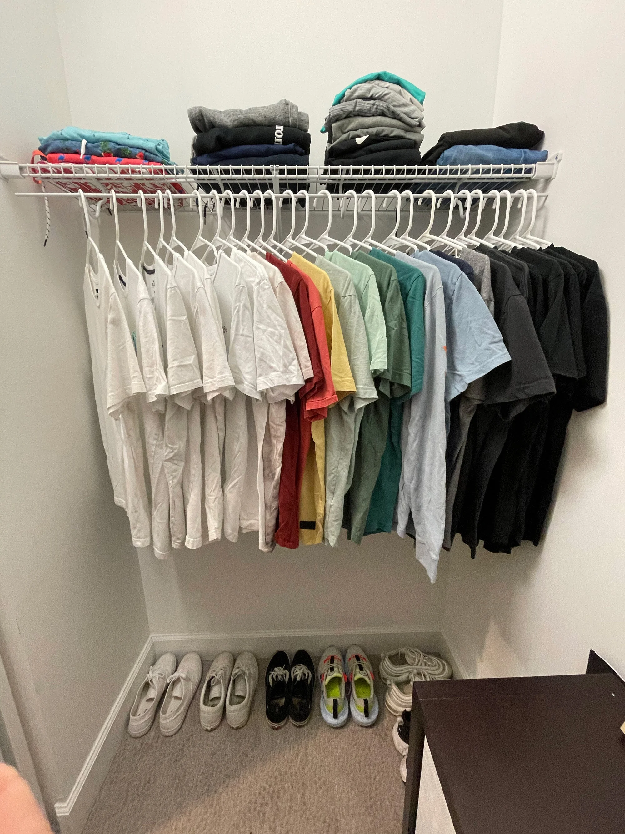 Left side closet after - color coordinated shirts