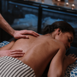 Person receiving a back massage in a spa setting