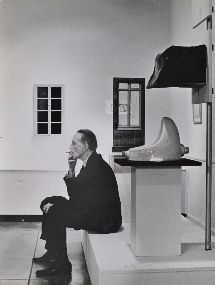 julian-wasser--duchamp-smoking-in-front-of-fountain-duchamp-retrospective-pasadena-art-museum.webp