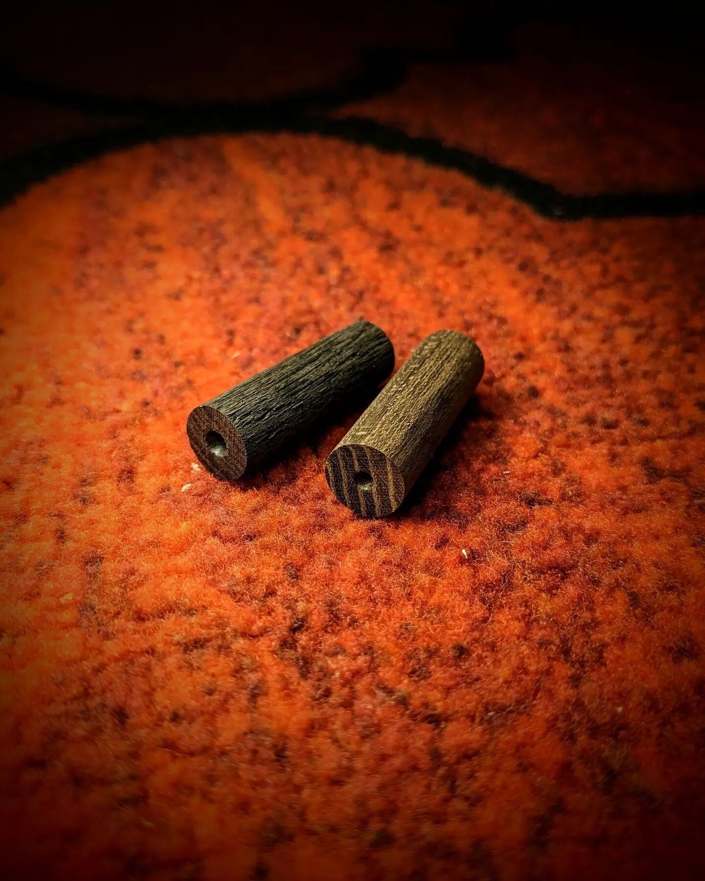 I'm doing a bit of wood turning today for a change of pace. These two blanks will soon become the end-pins/strap buttons for a pair of ukuleles I'm working on. 

The one of the left is 5,000yo Fenland Bog Oak, and the one on the right is Fumed Laburn