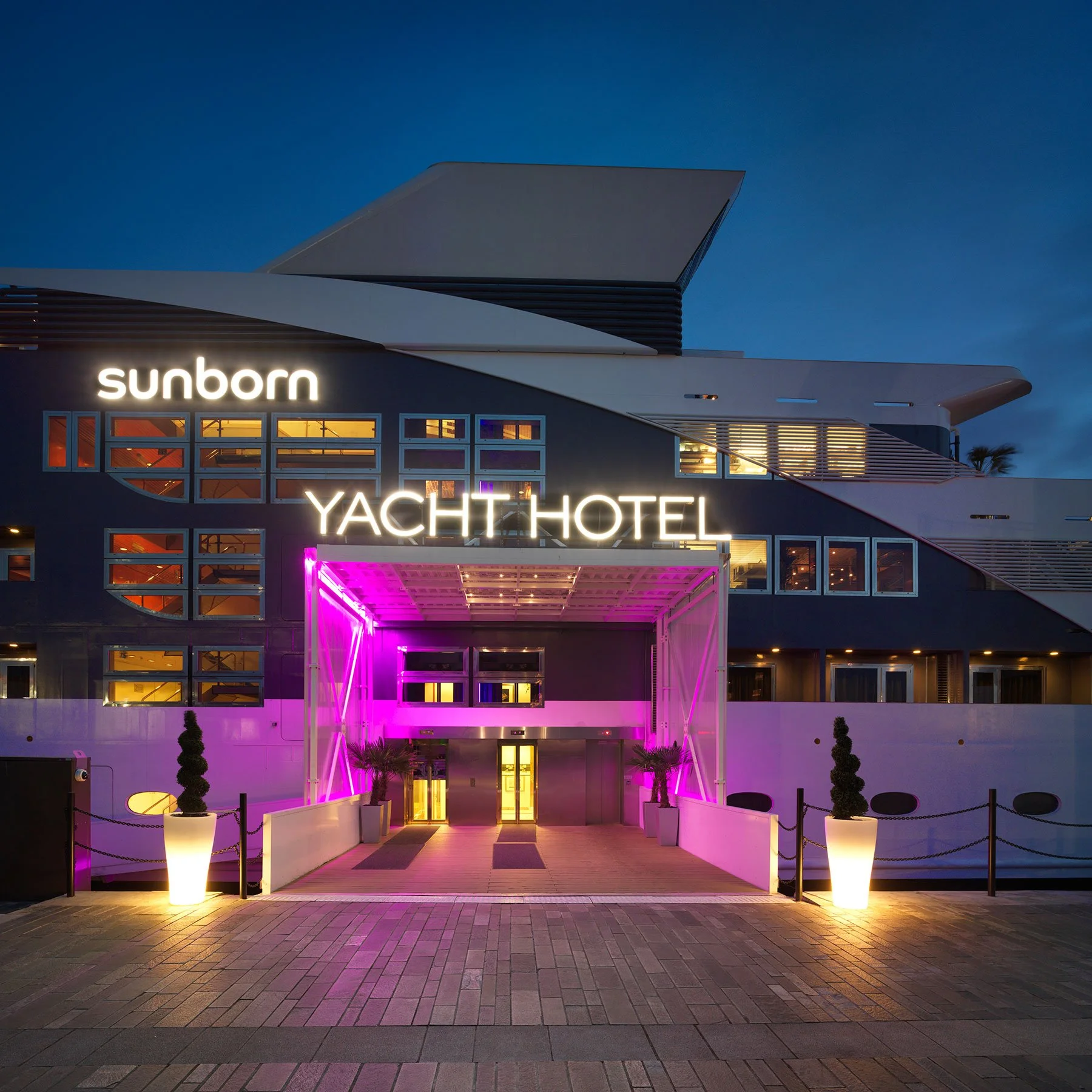 Hotel entrance of Sunborn London Yacht Hotel lit up at night, Royal Victoria Dock.
