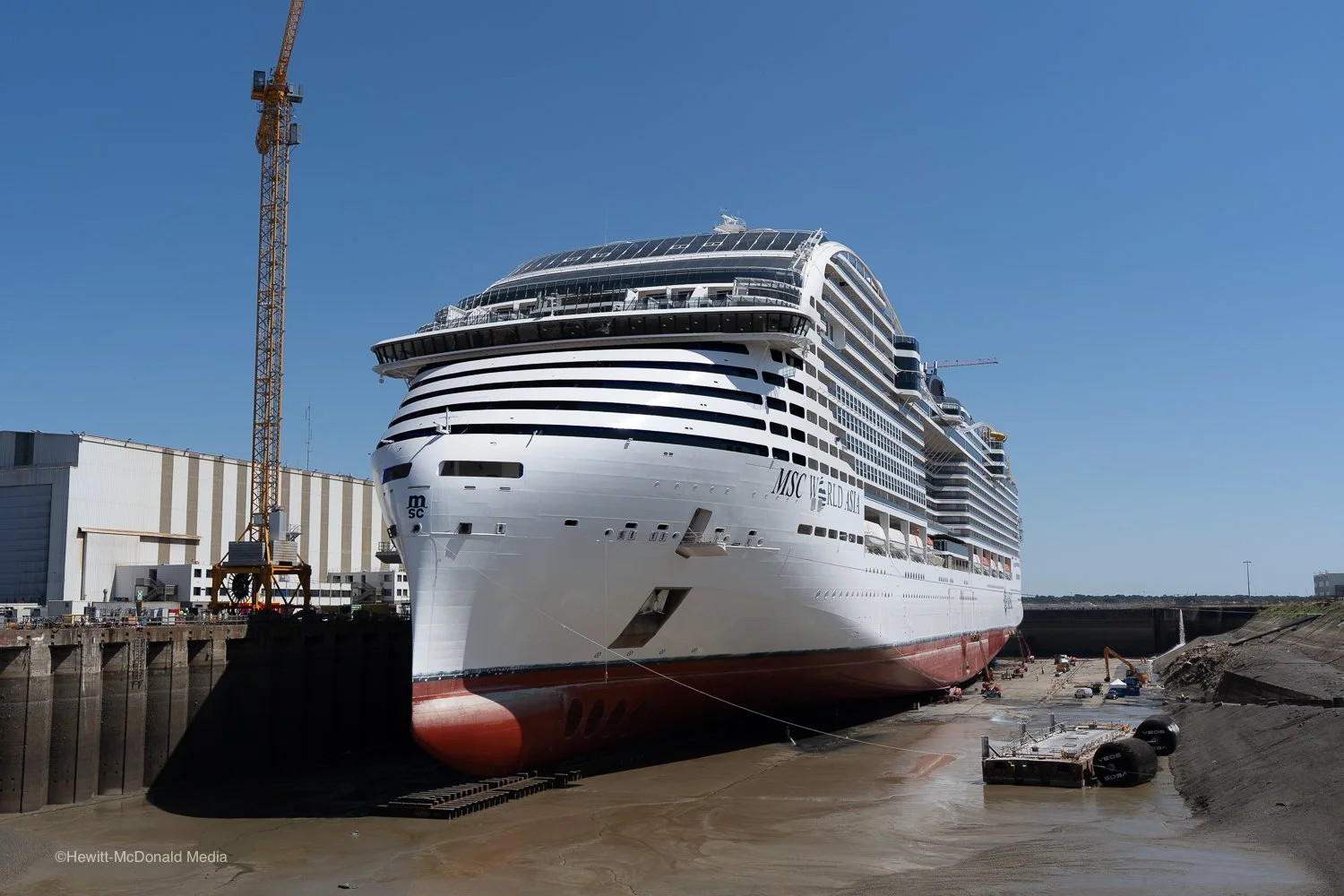 Exterior view of the 215,000-ton MSC World Asia cruise ship being assembled in dry dock