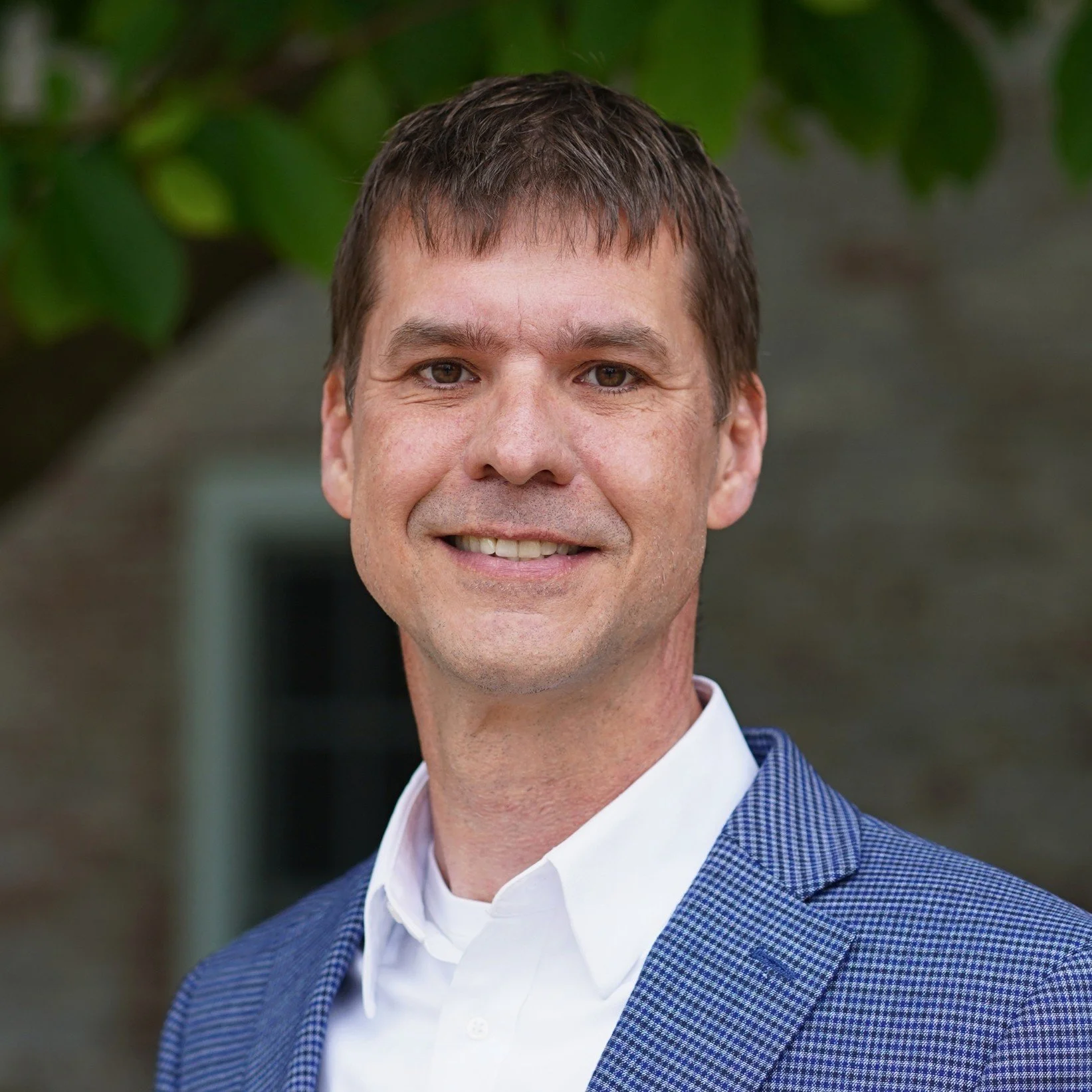 Dr. Joel Hathaway smiling, outdoor headshot