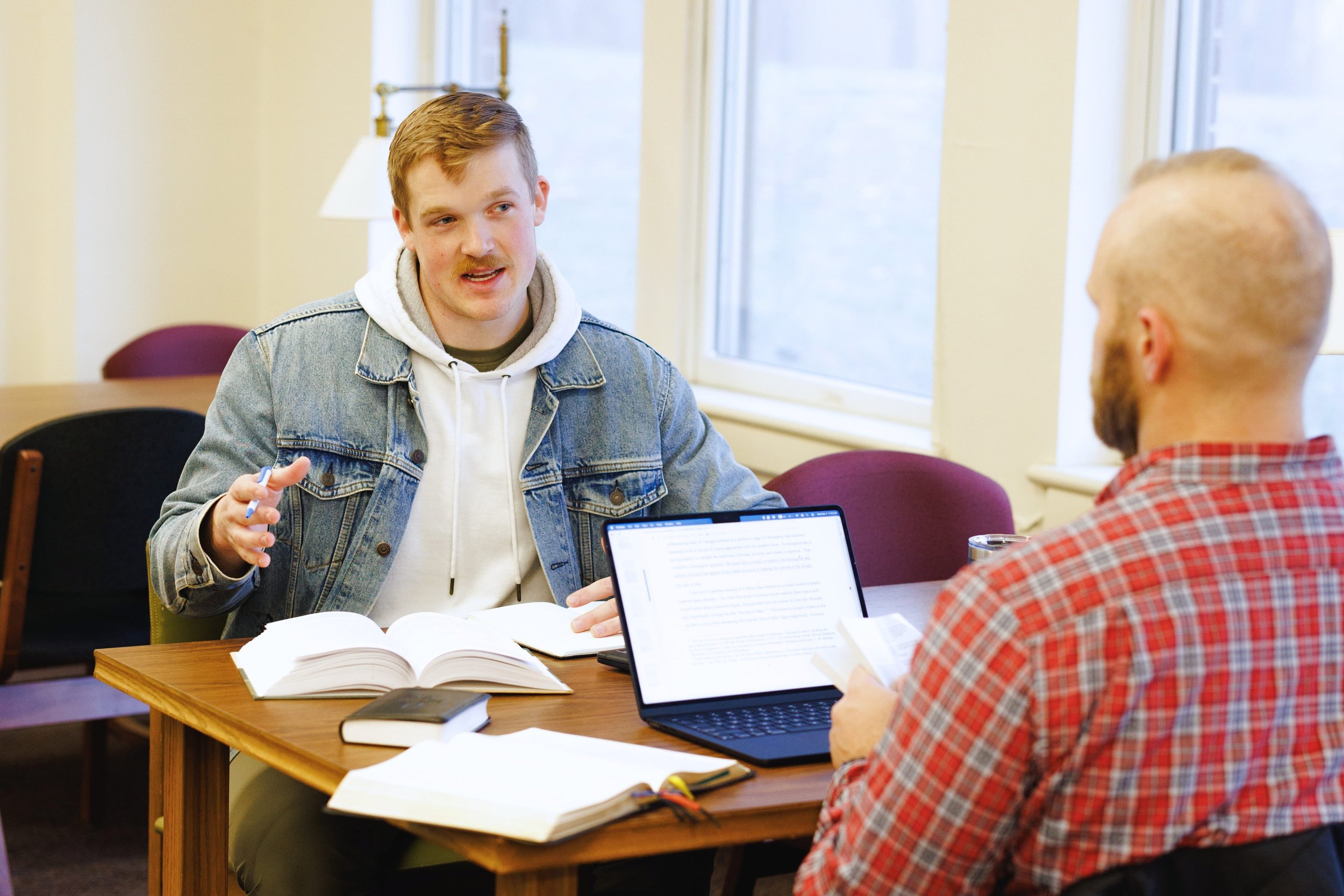 Students studying and talking together at a table