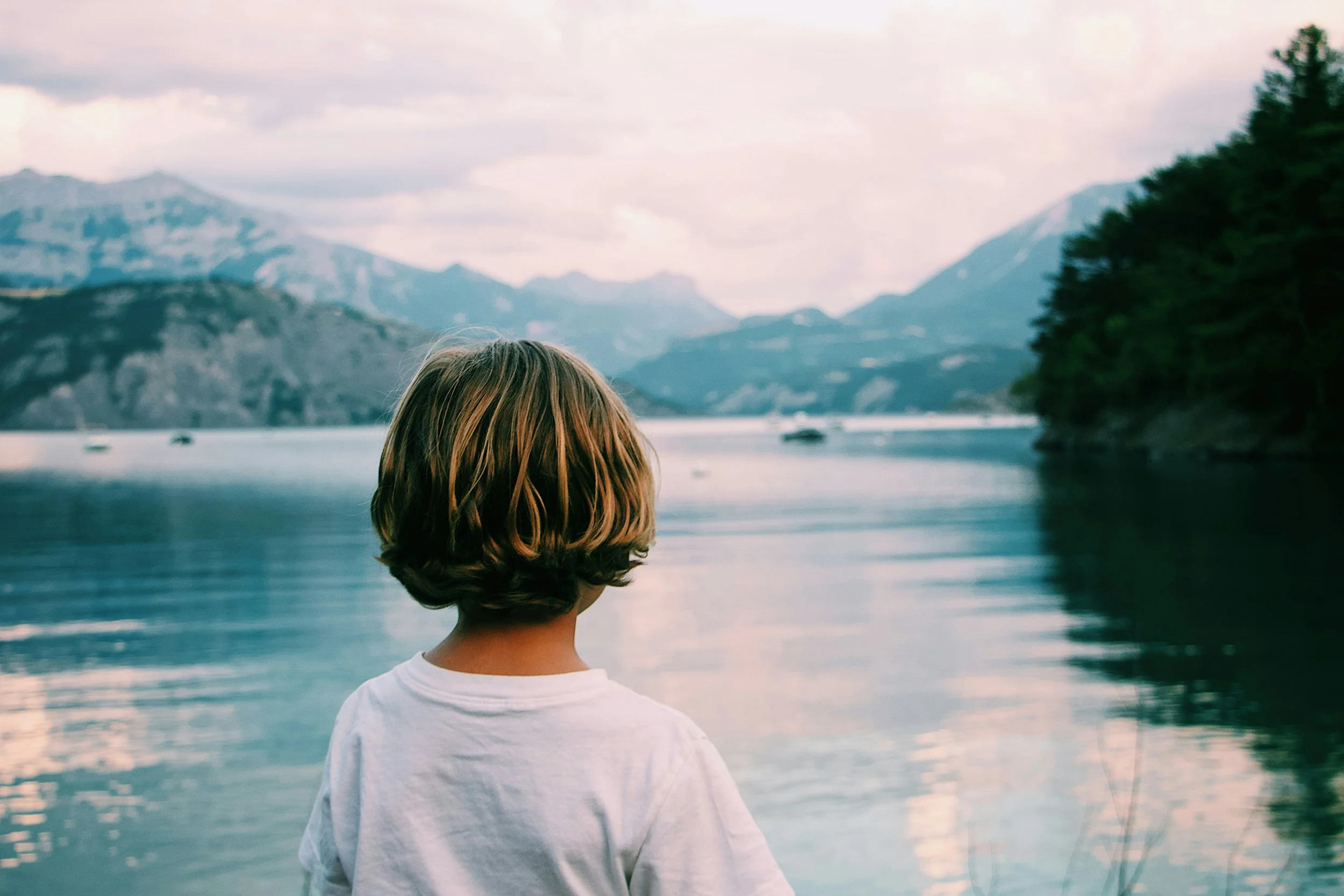 Boy standing by the lake