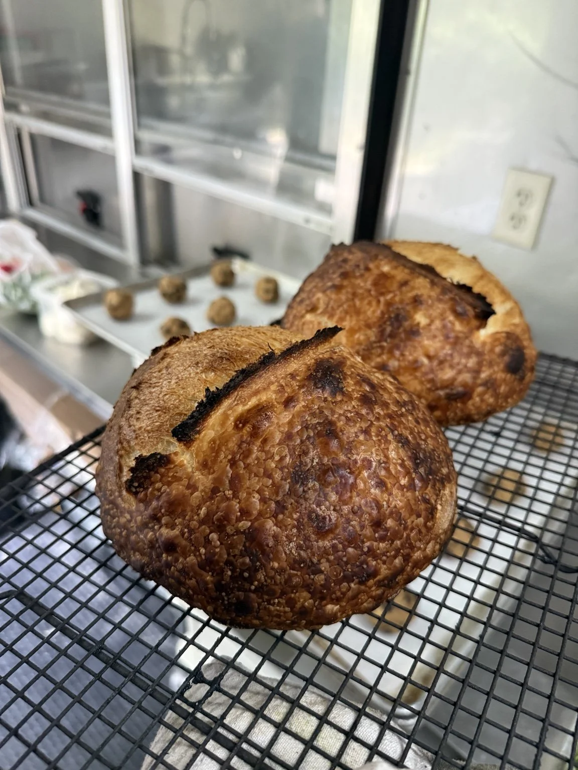 Freshly baked bread loaves cooling on a rack.
