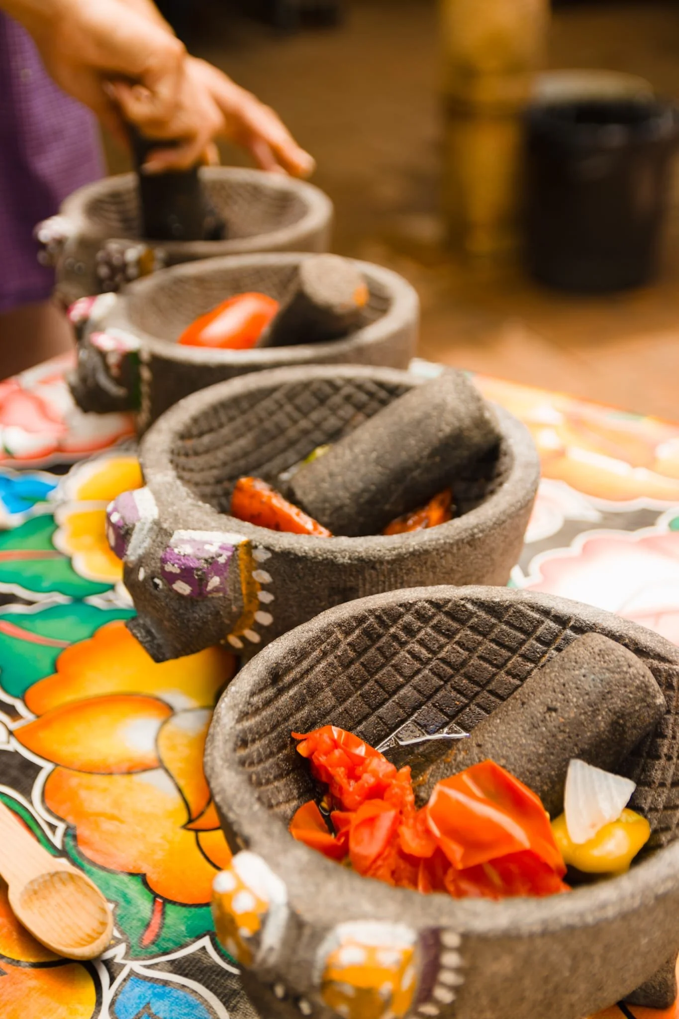 four molcajetes ready to mash some salsas to enjoy our feast with some quesadillas and empanadas at the table
