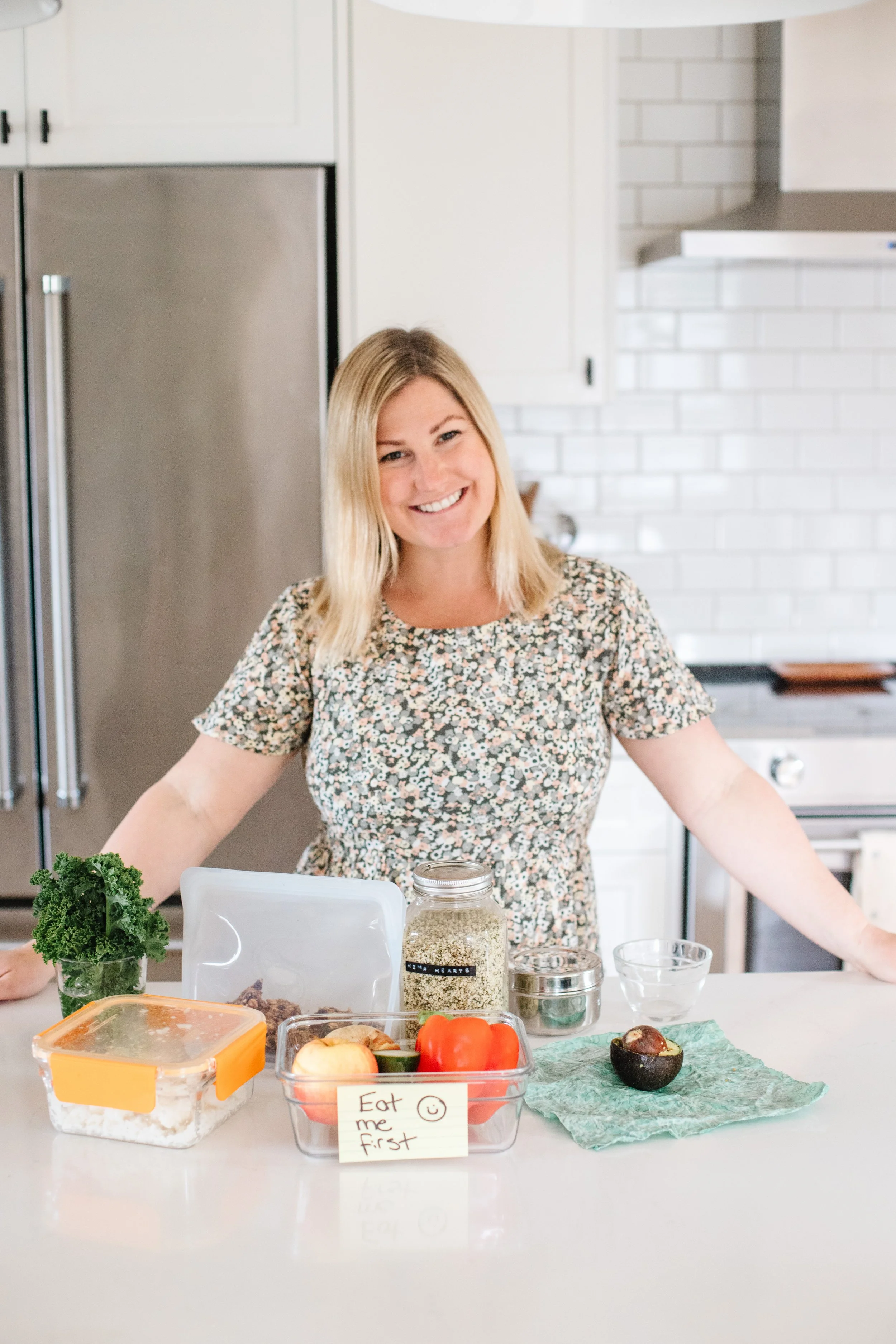 Tasha from The Purposeful You with food storage containers on her counter